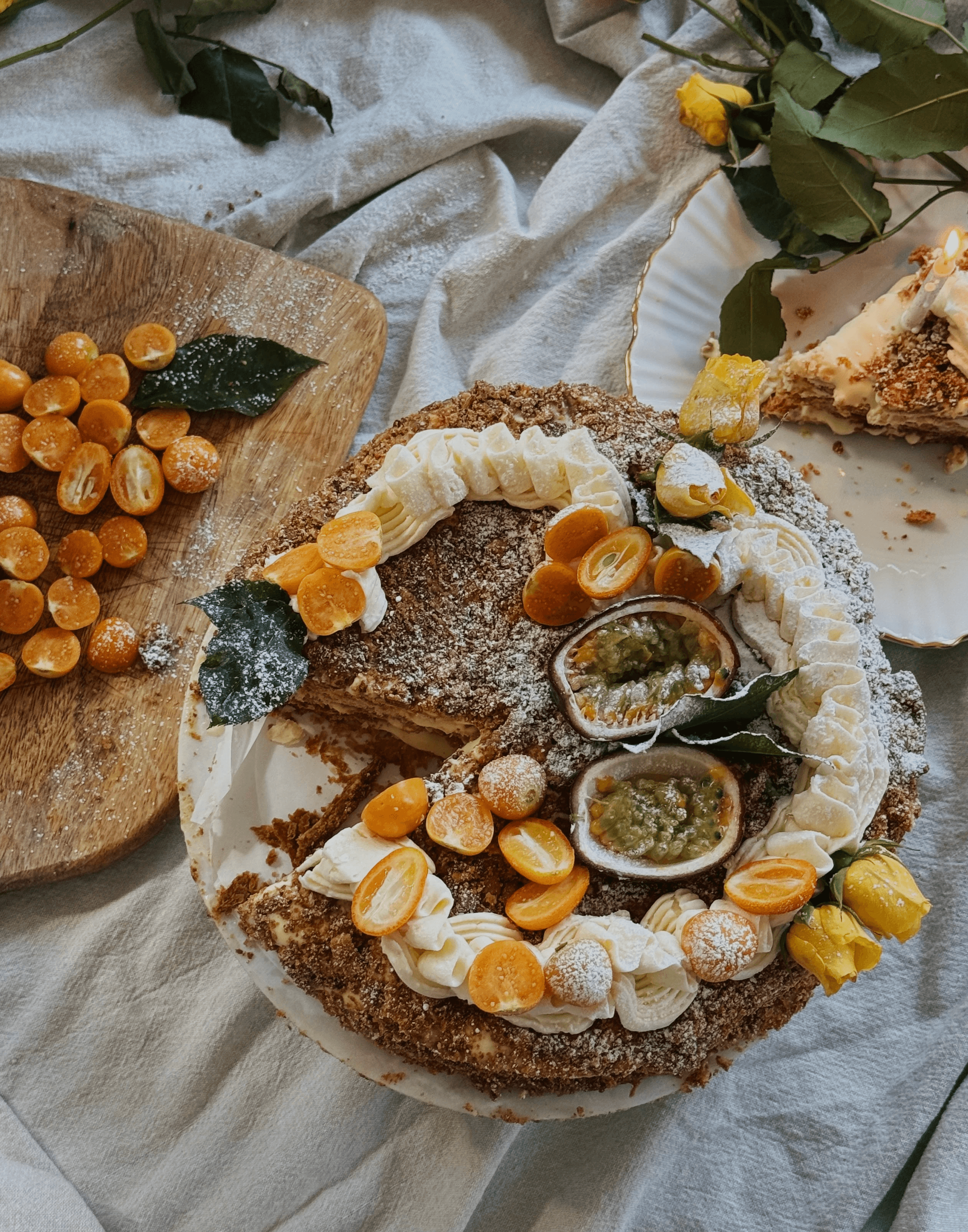 Napoleon cake decorated with physalis, passion fruit, and whipped cream swirls