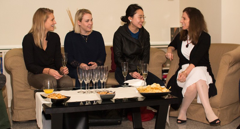 women seated with champagne glasses