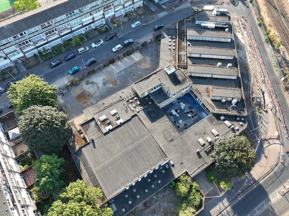 Top-down aerial drone roof survey of a commercial building complex with flat roofing and skylights