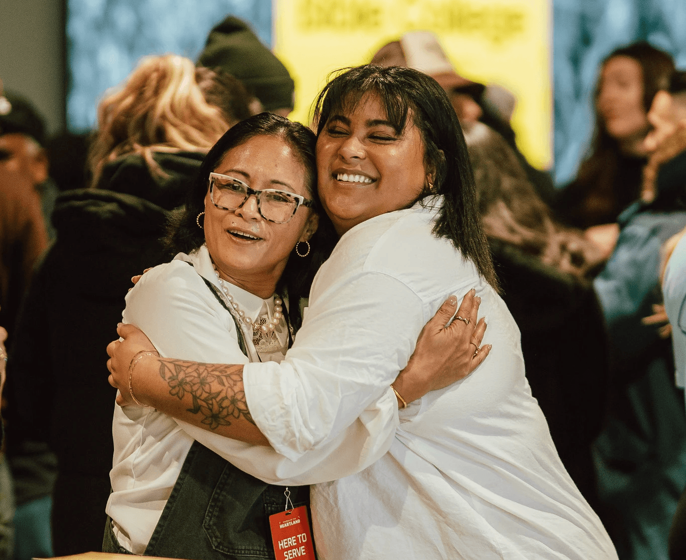 Two women embracing and smiling.