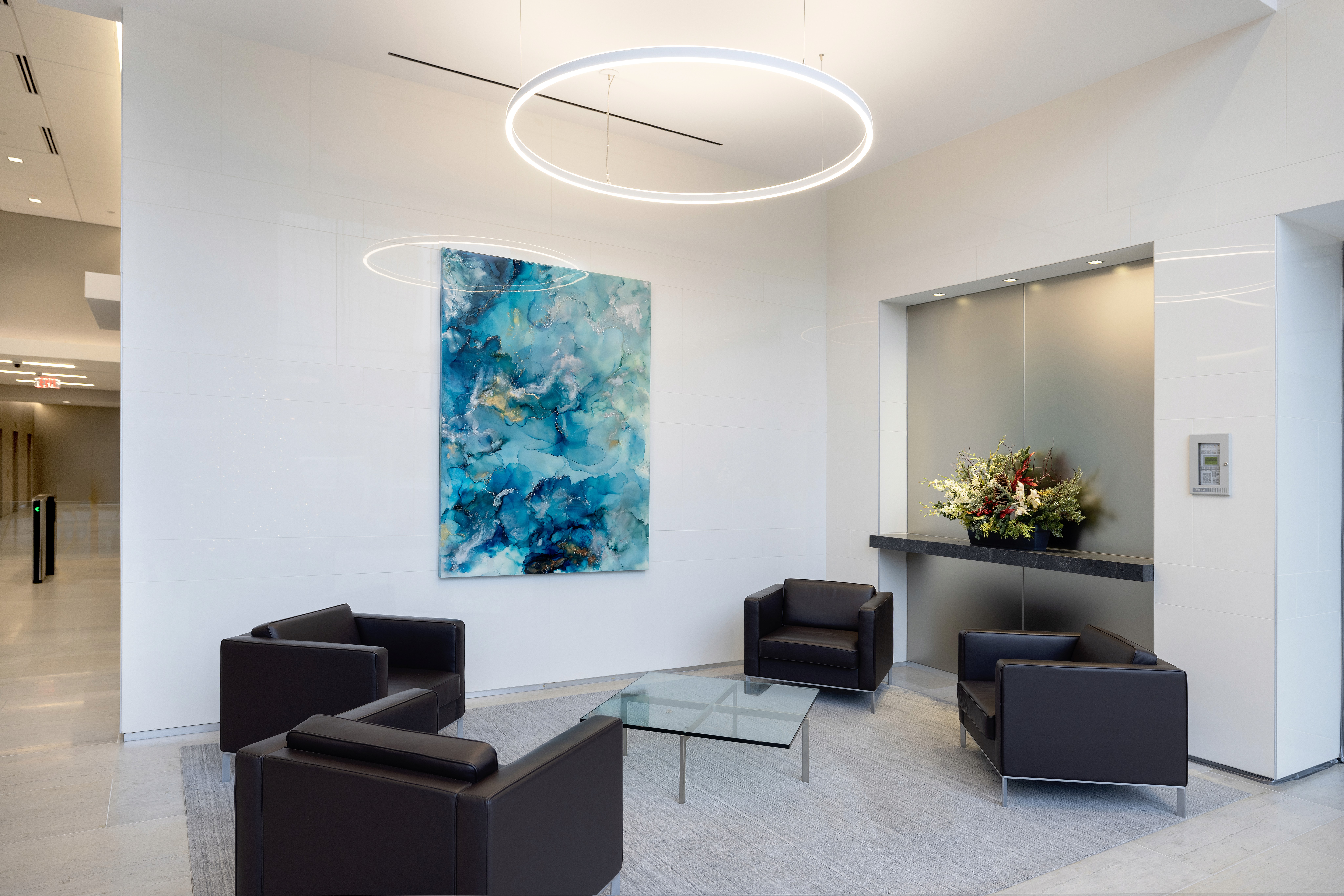 A woman observes framed black-and-white photographs in warm golden light