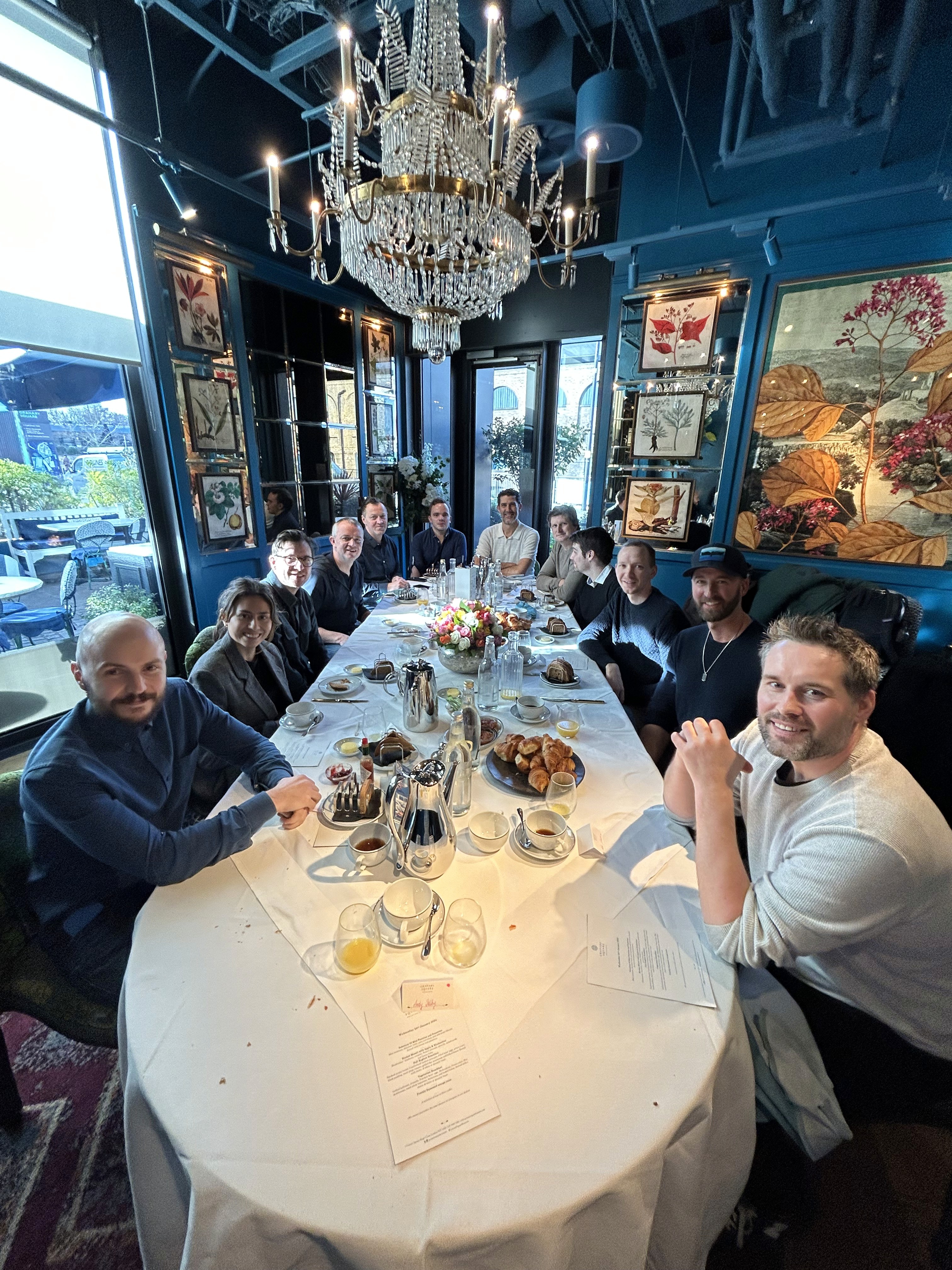 A group of people having a discussion over a meal