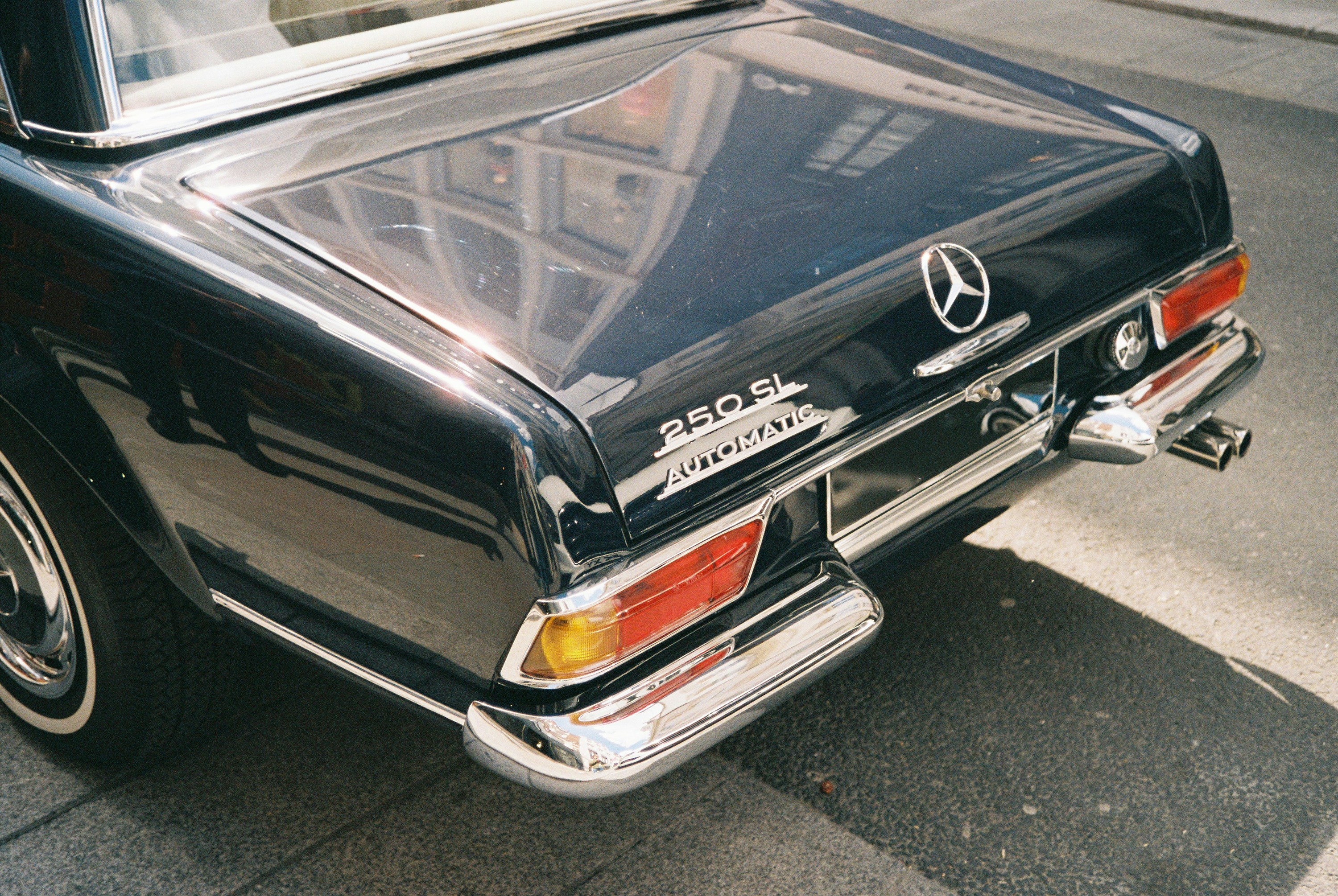Rear view of a vintage black mercedes-benz 280 sl.