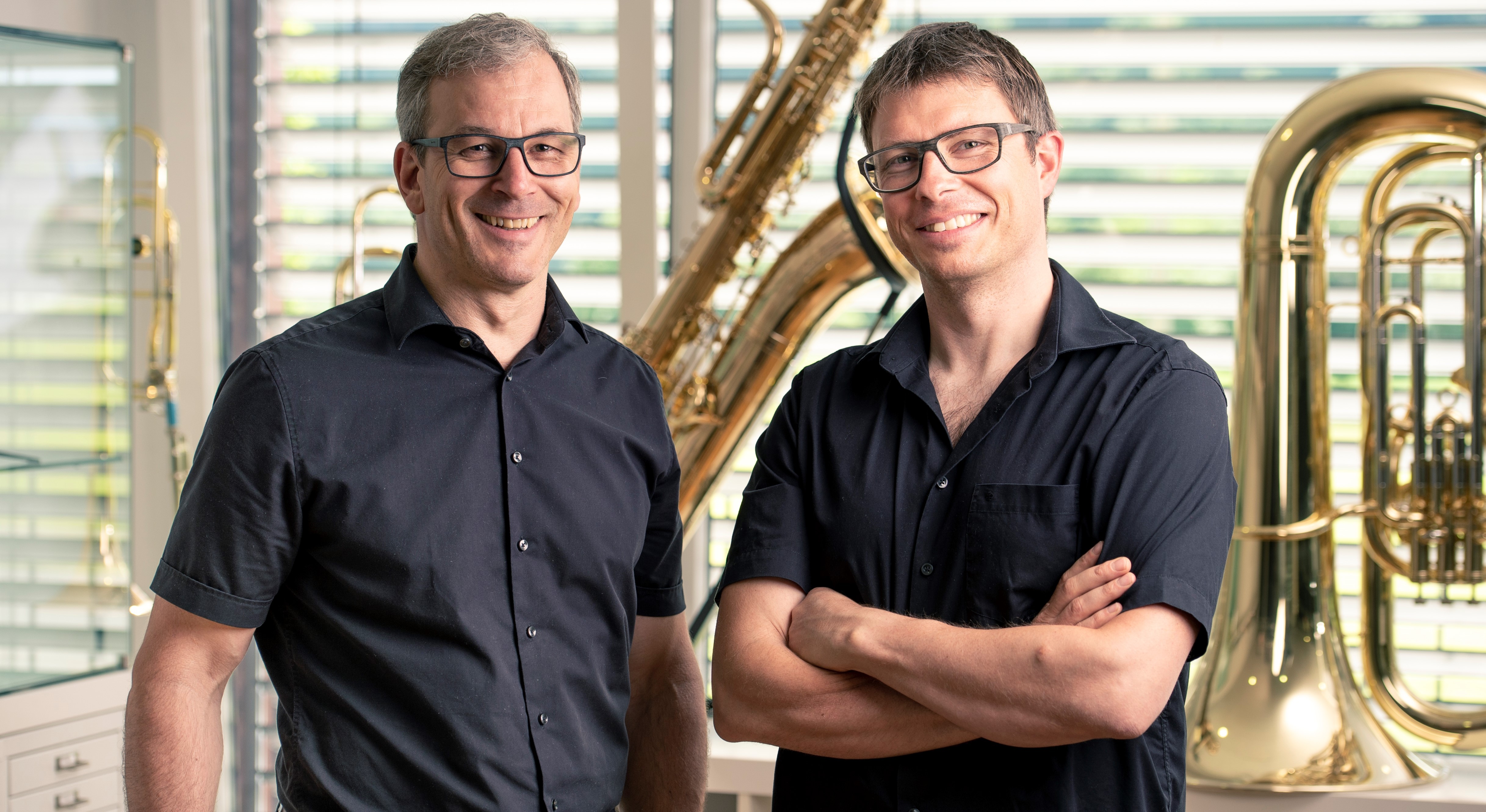 Two men in a creative studio discussing content ideas for production.
