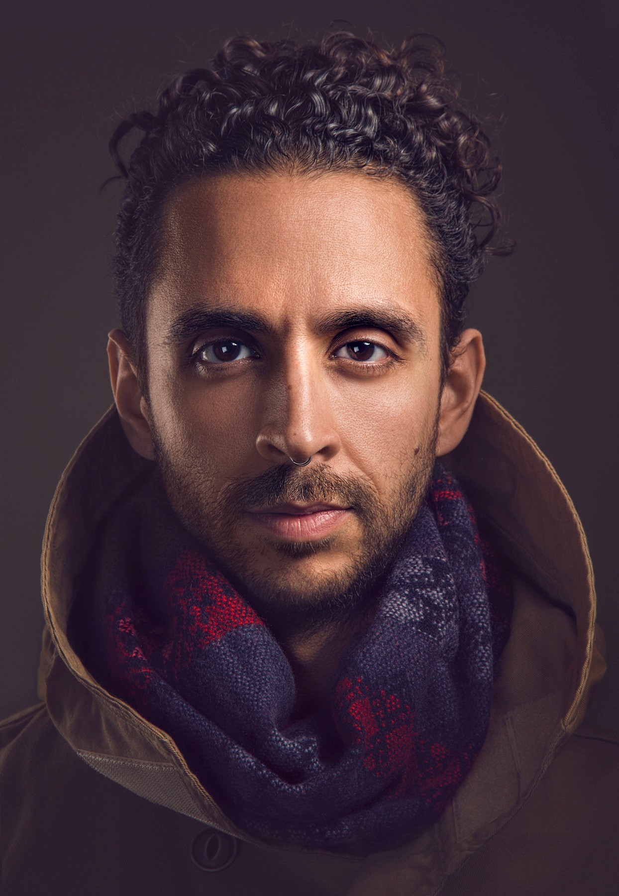 Natural light portrait of South Asian woman smiling with scarf