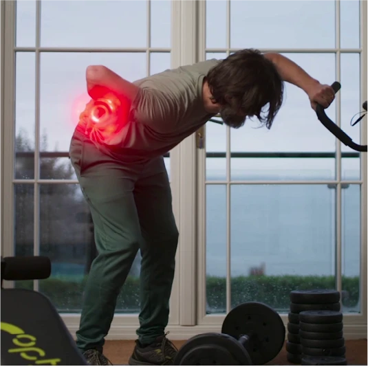 Man bending over while exercising, clutching his lower back in pain