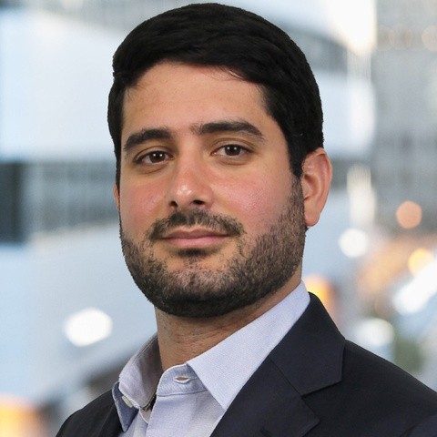 two people looking at a tablet and smiling