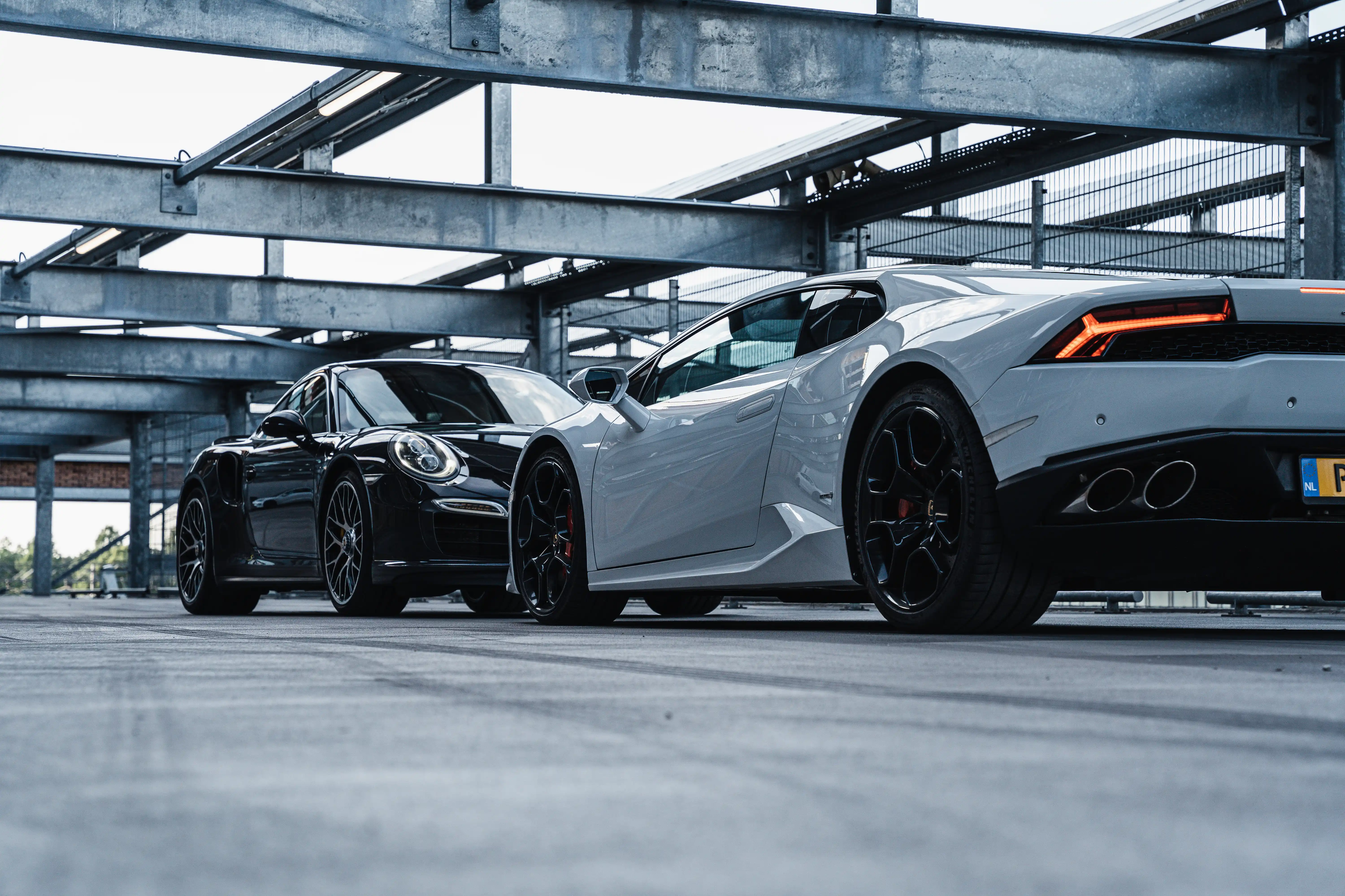 Parking garage with high-end cars like Porsche and Lamborghini