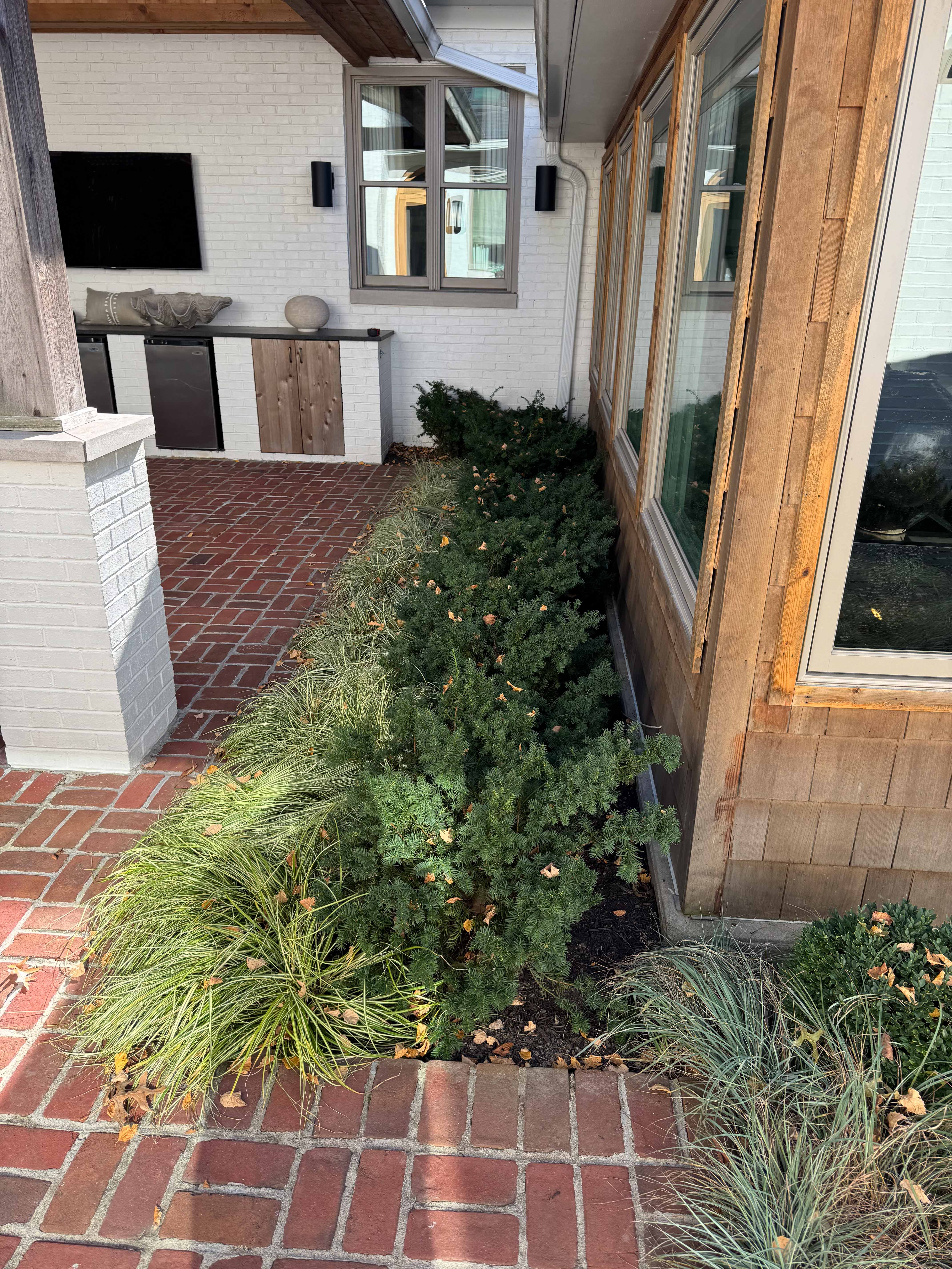 Drainage system routing around landscaping and hardscape