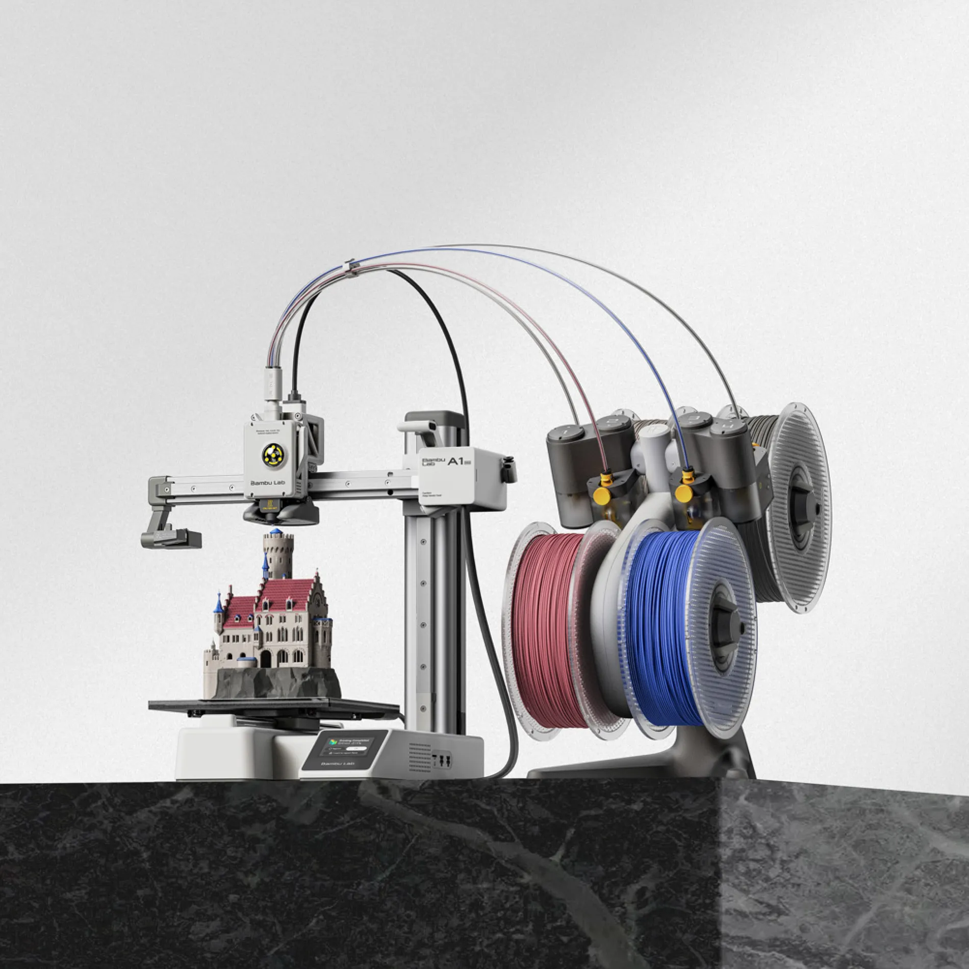 3D printer with AMS on black counter