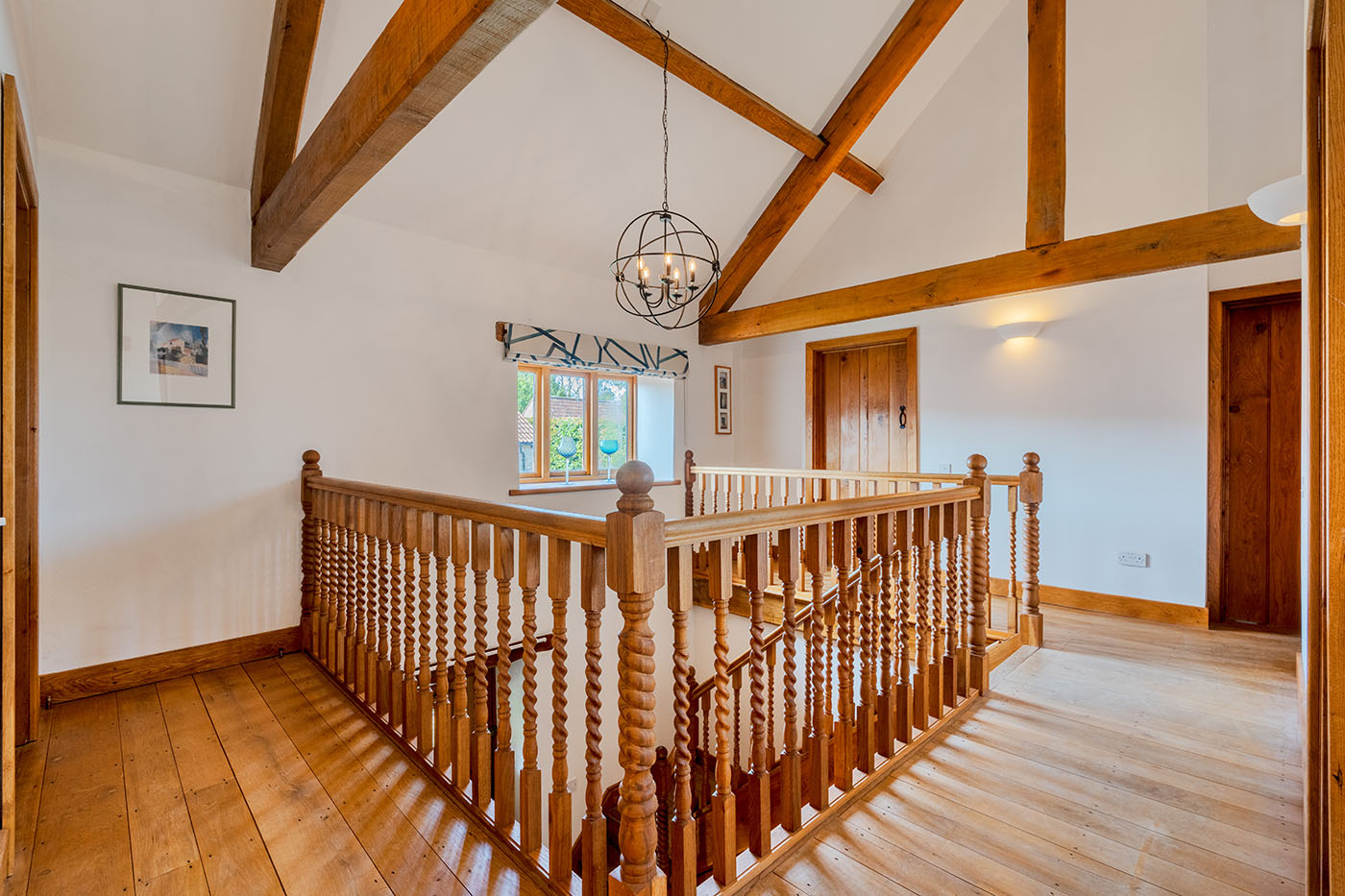 First-floor landing with exposed timber beams and wooden balustrade