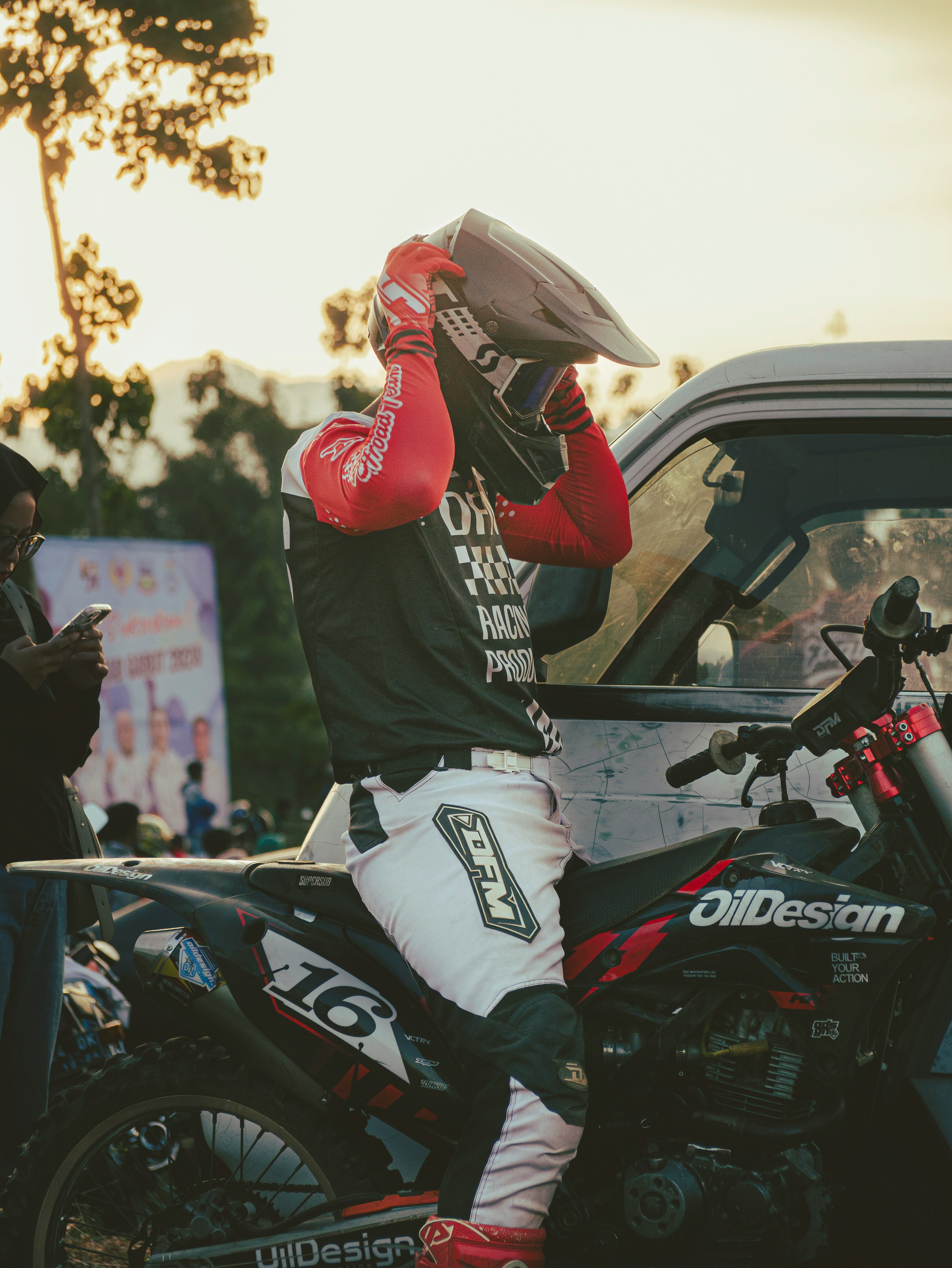 A man sitting on top of a motorcycle next to a truck