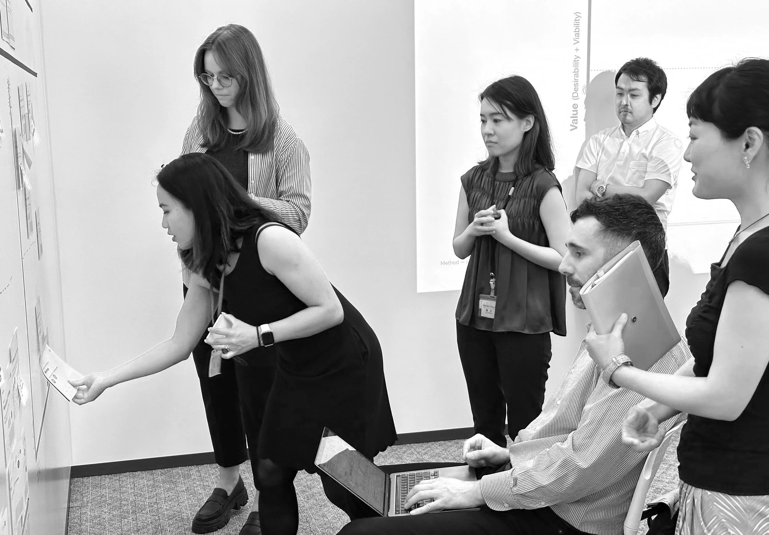 Design team member facilitating discussion during Hitachi communication platform workshop