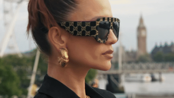 Woman hugging Shiba Inu dog in front of white fence