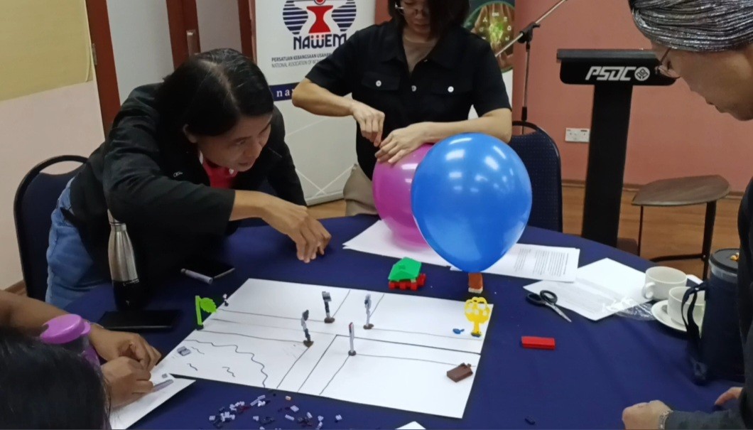 two ladies looking at a laptop and smiling