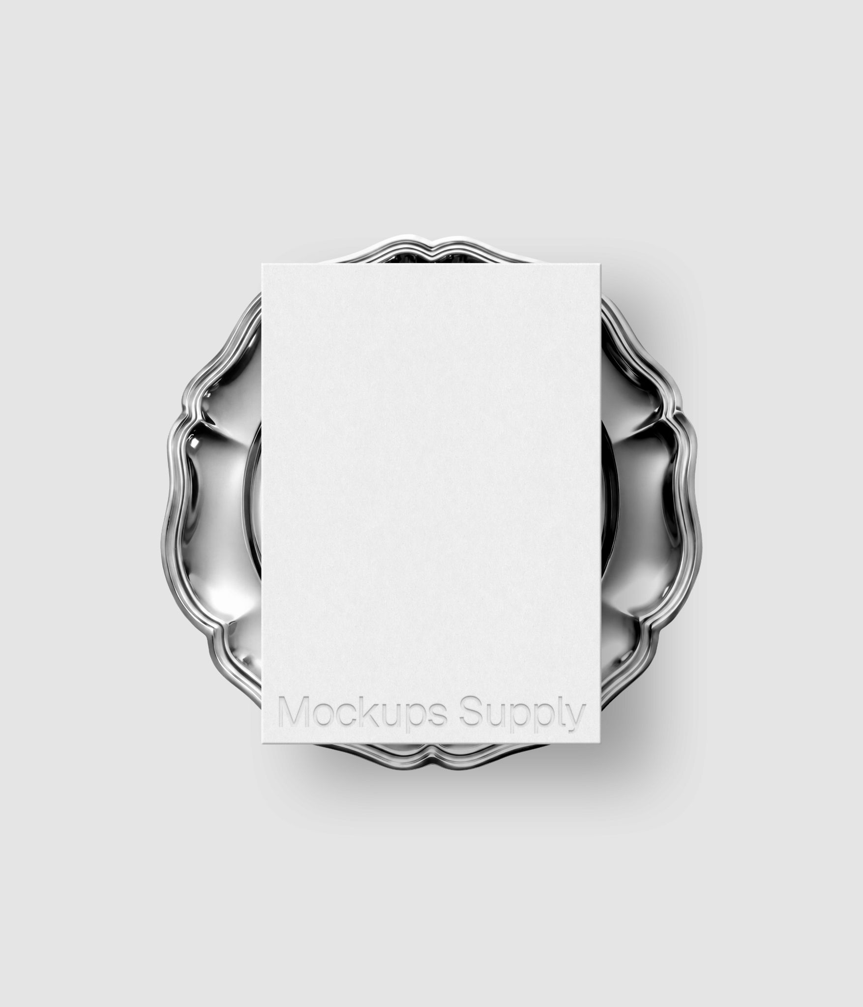 Paper card mockup with embossed typography on circular metal plate for logo design and identity showcase