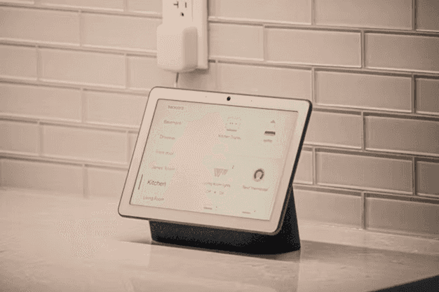 A modern smart home living room with AI-connected devices — speaker, lights, and camera