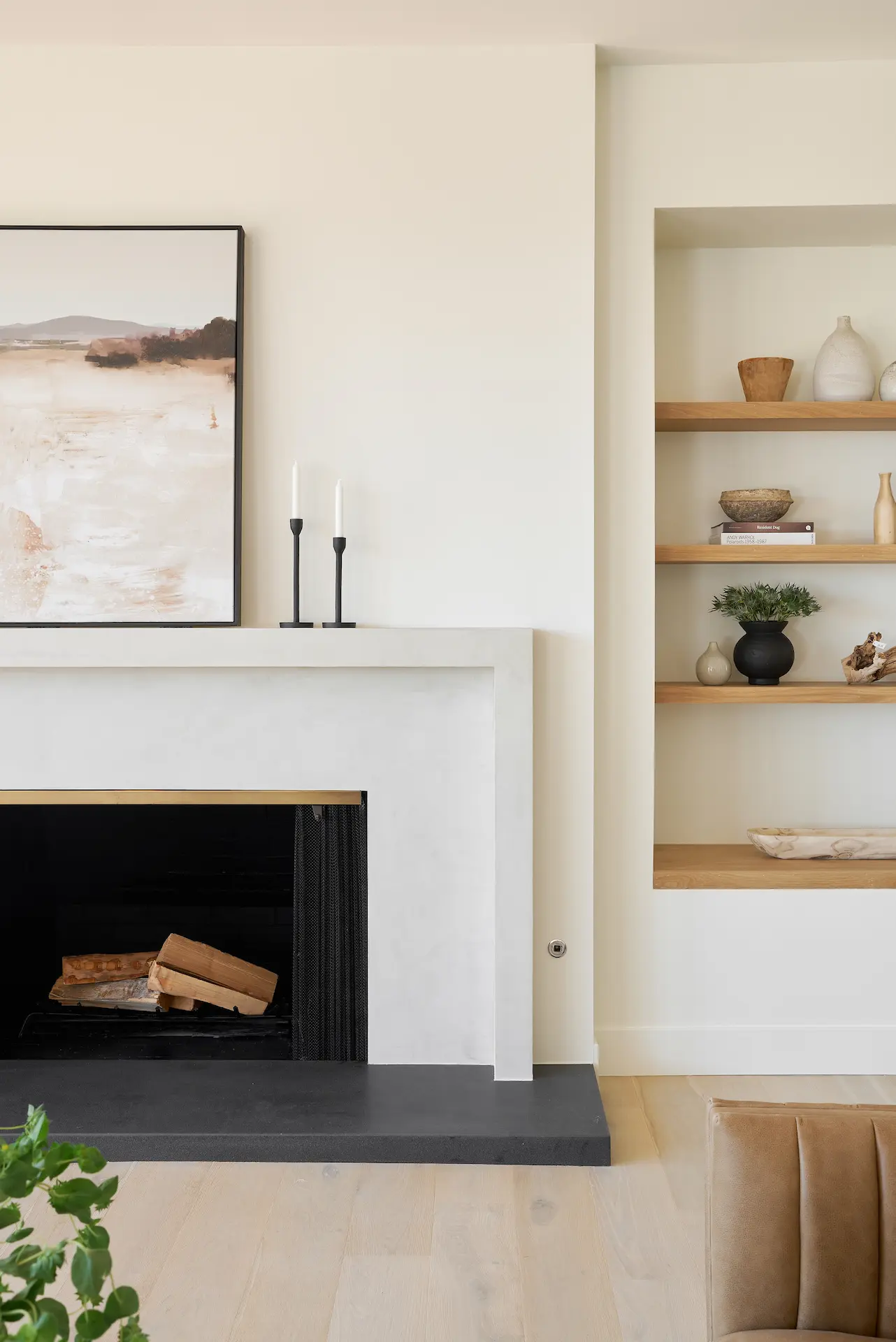 First angle view of the living room showcasing the fireplace and built-in shelving. Photo by Todd Huge.