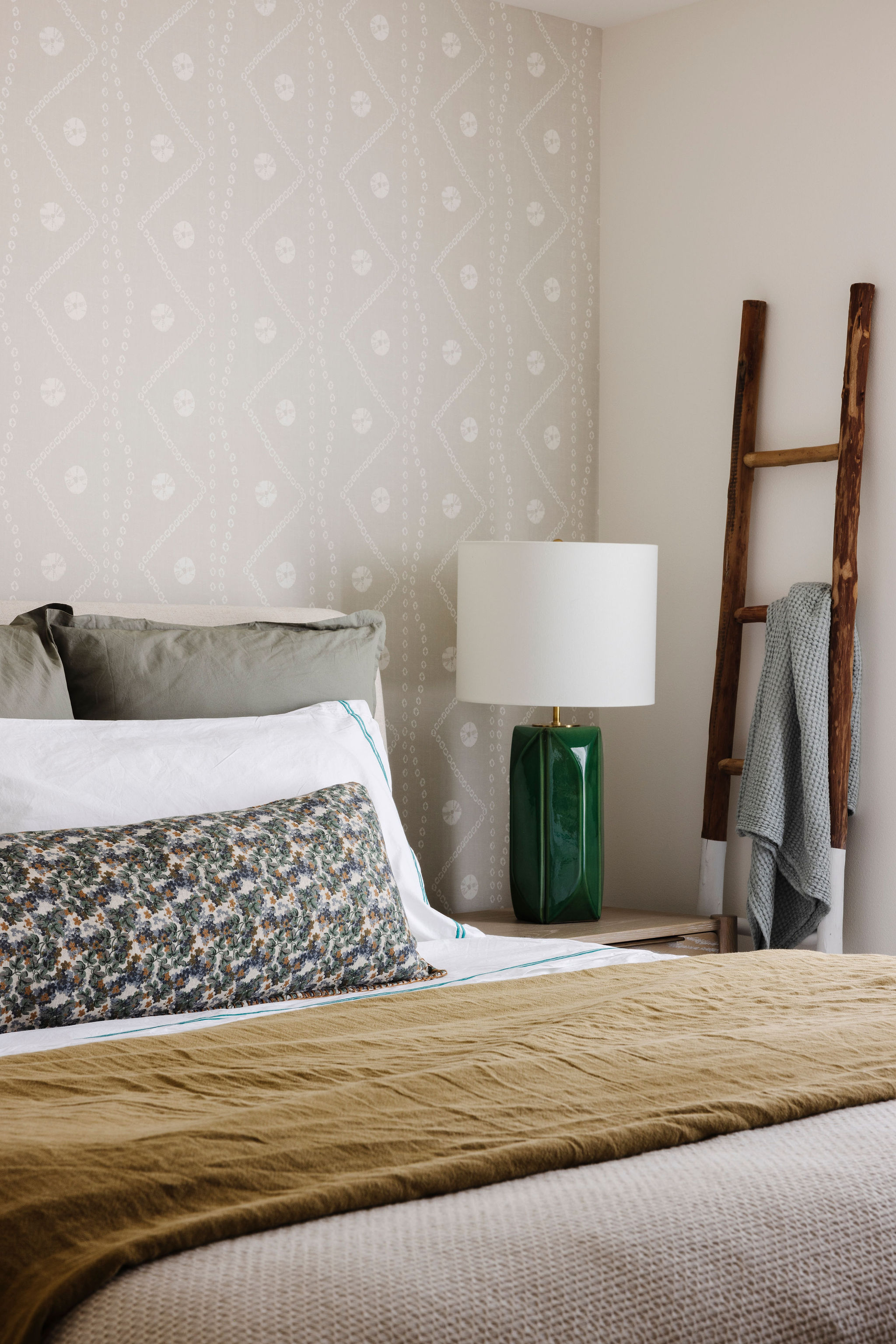 Cozy guest room with soft hues, layered bedding, and thoughtful decor that offers a tranquil retreat for visitors, complete with natural light and a welcoming ambiance.