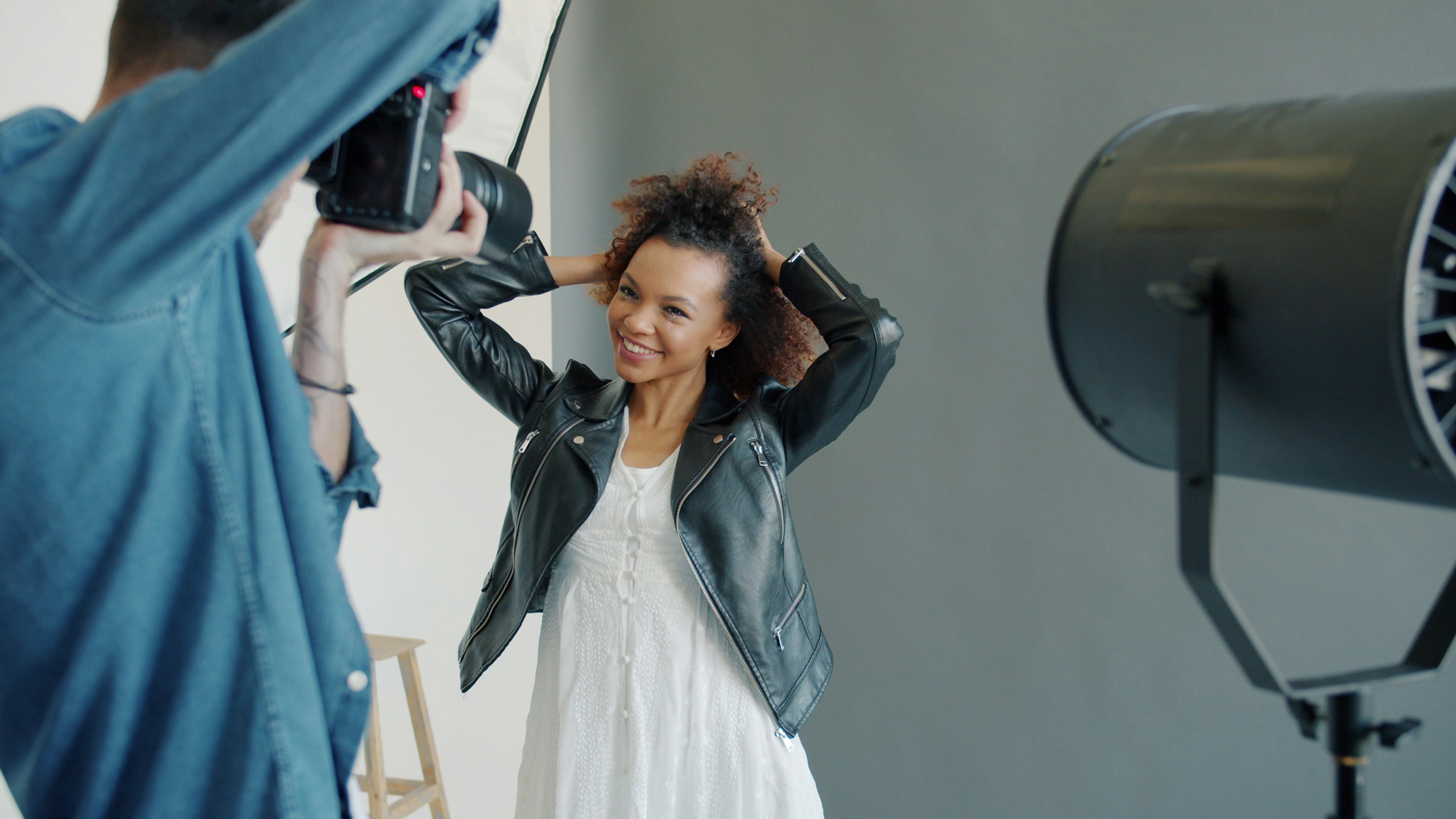 Model posing for photographer with studio lighting