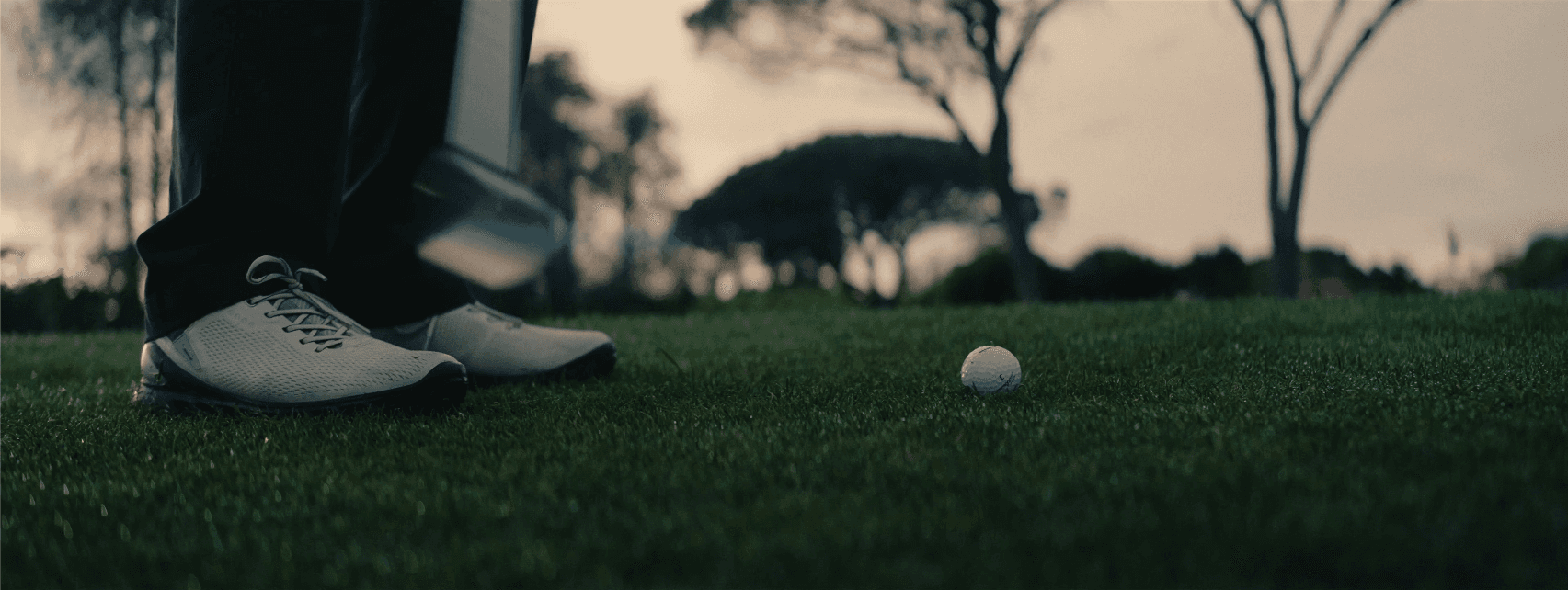 Golf club hitting ball