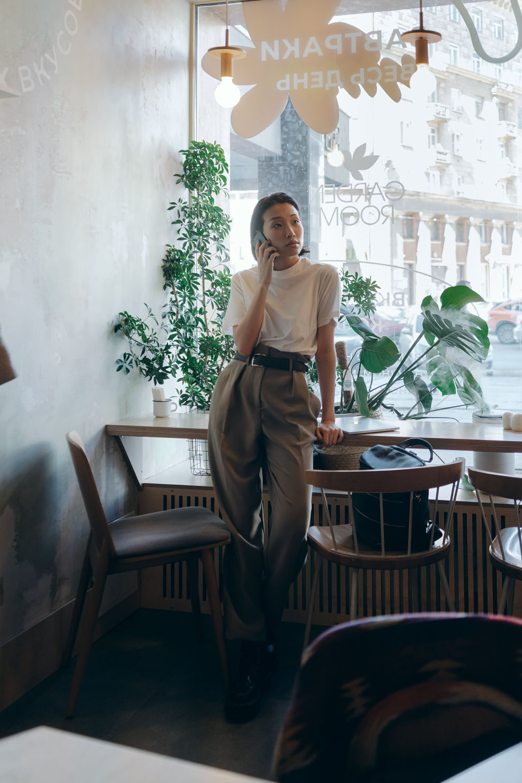 Women leaning against counter taking phone call