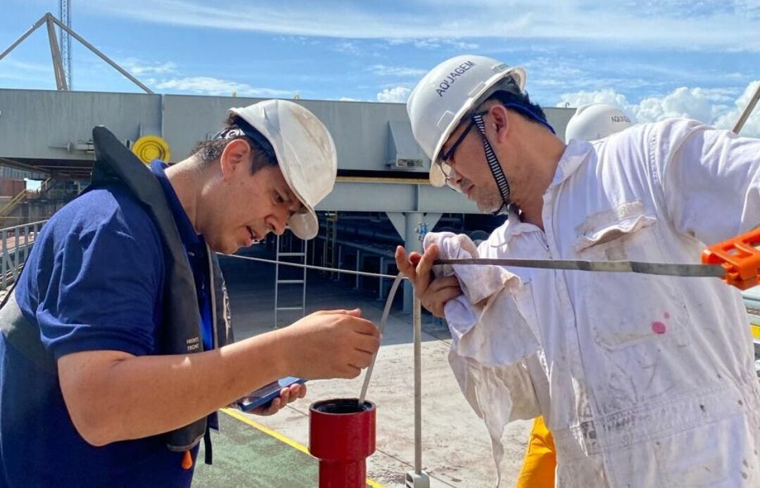 Marine surveyors conducting bunker fuel sounding on board a vessel during a bunker quantity survey, verifying delivered fuel volumes to prevent quantity disputes.
