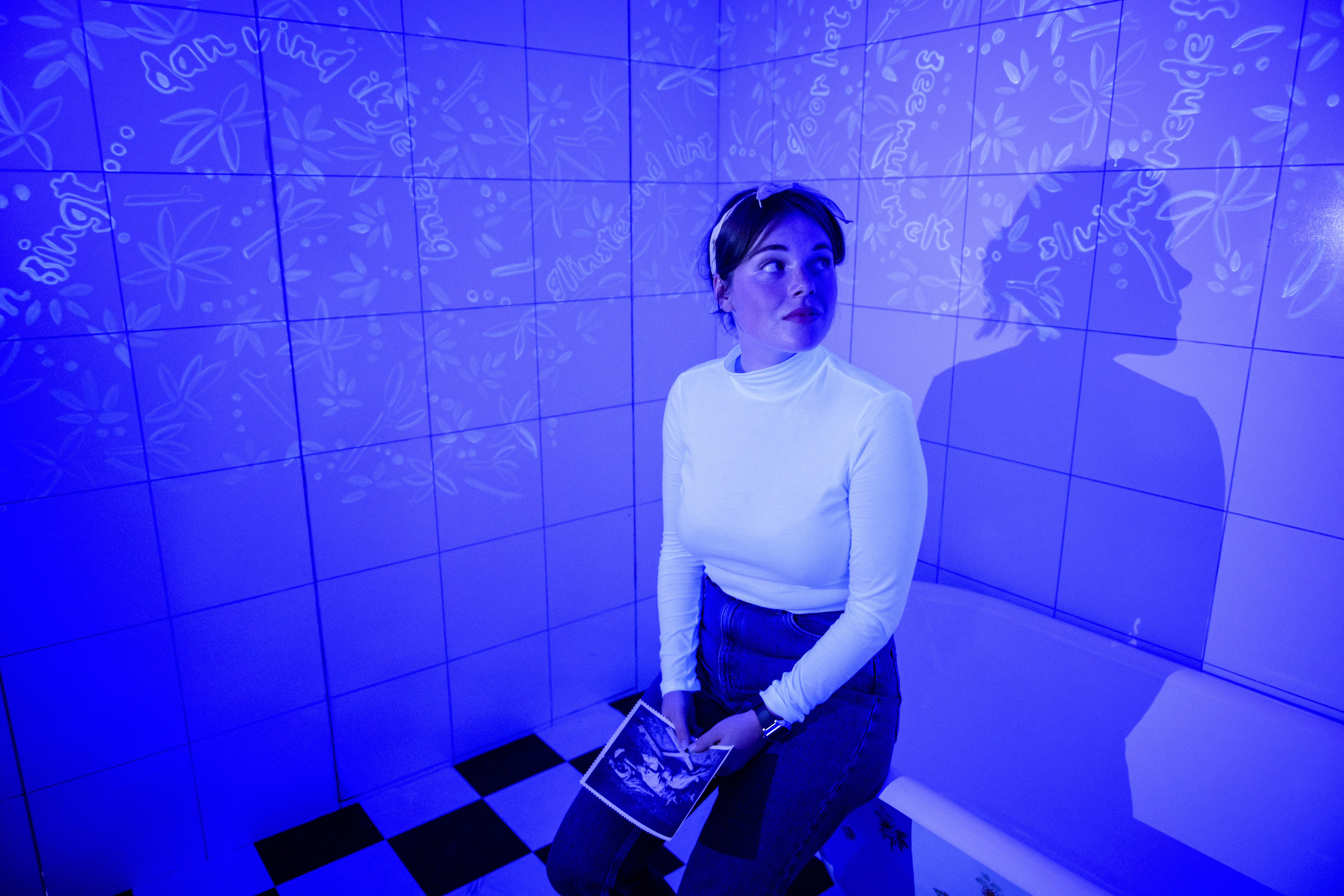 woman sitting around table holding tablet