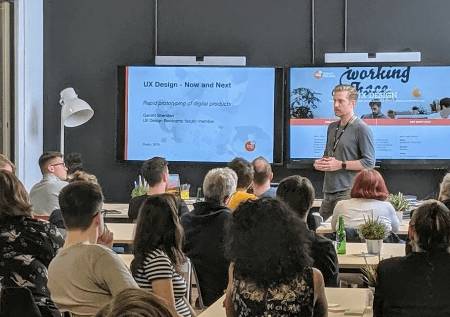 Garrett presenting to a room of people