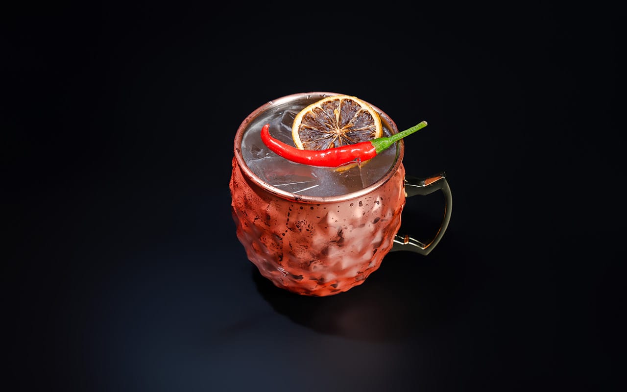 a black plate topped with sushi covered in sauce