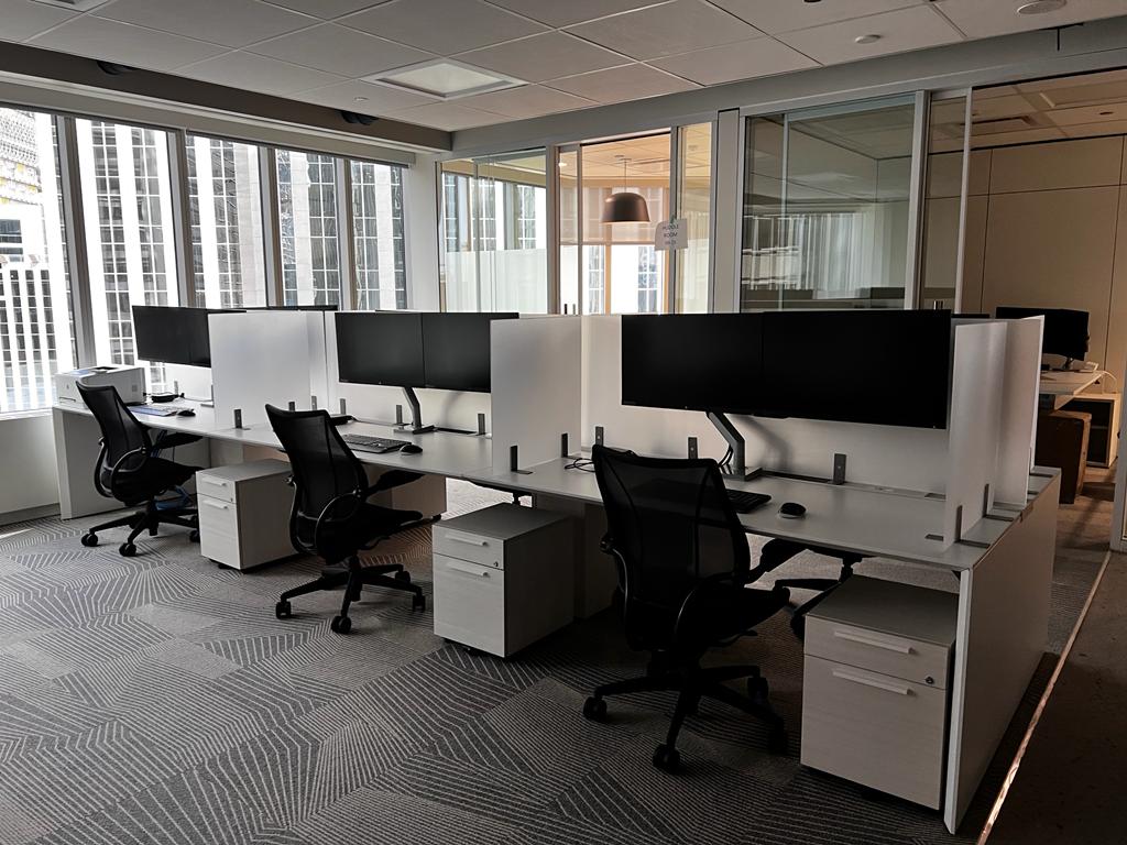 IT office relocation team disconnecting and packing workstations for an office move