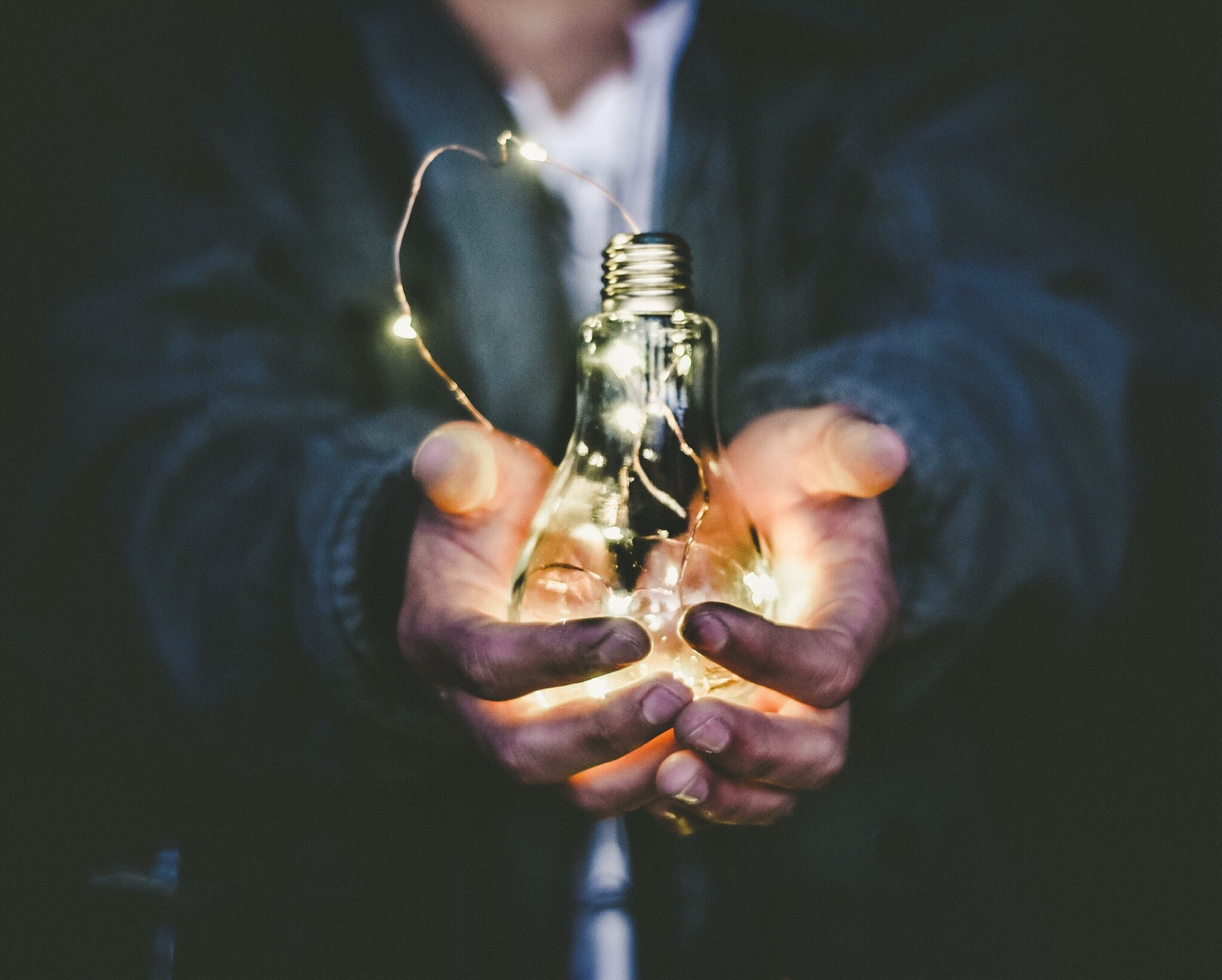 A person holding a light bulb - as a ray of hope to get to know the solution of setting up DMARC