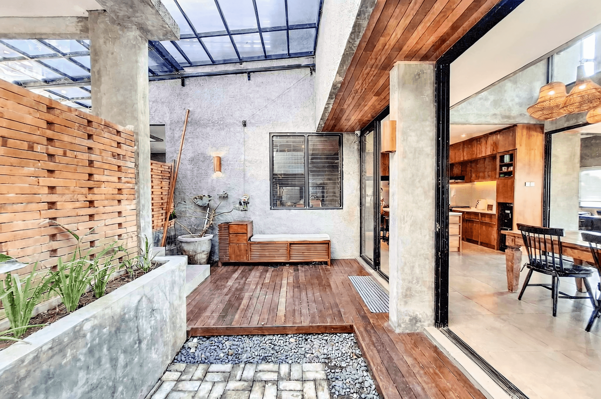 Architectural courtyard with sliding glass doors. Premium real estate consultancy for high-end Pererenan estates.