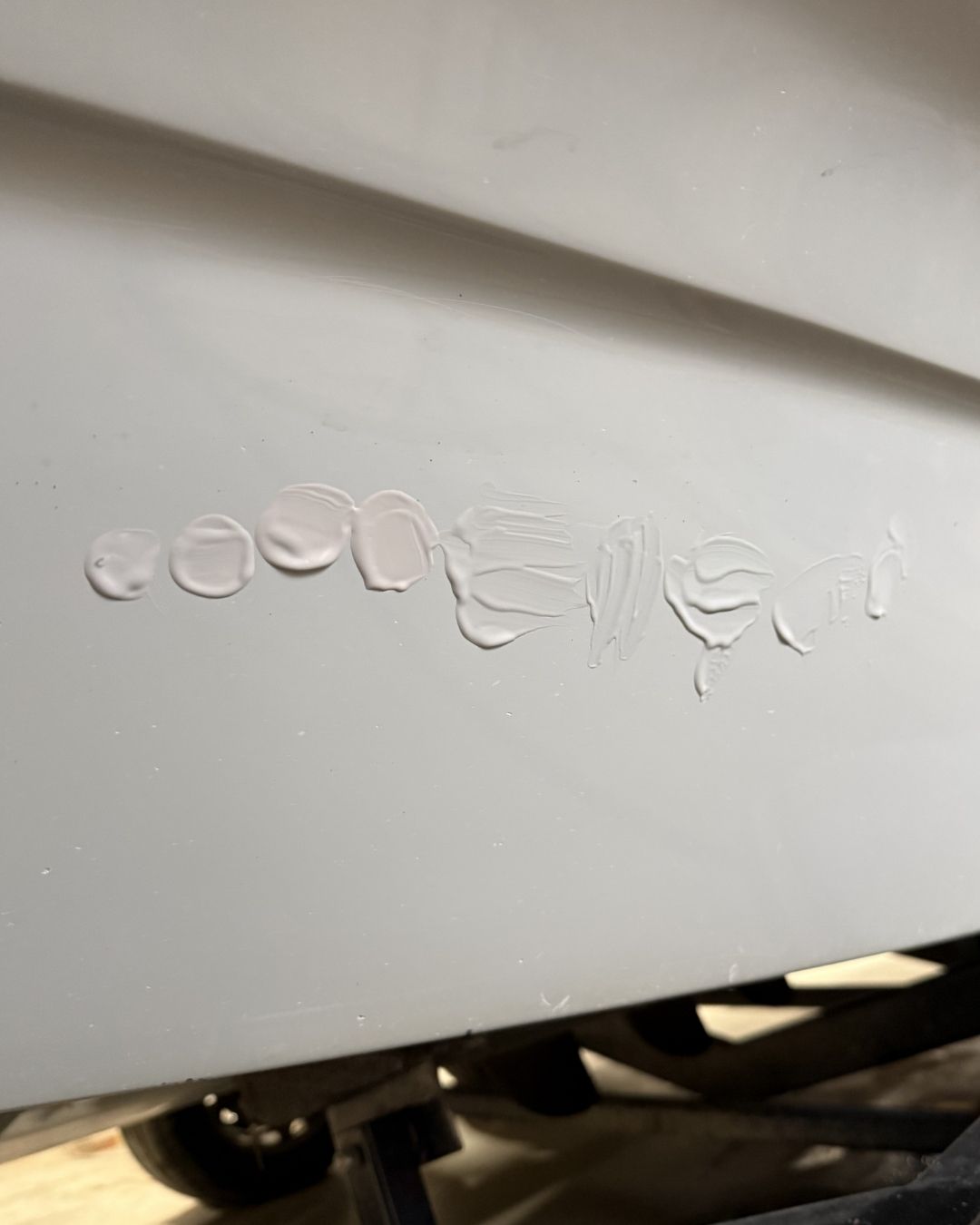 Gel coat that has been swatched onto the side of a boat for perfect colour matching