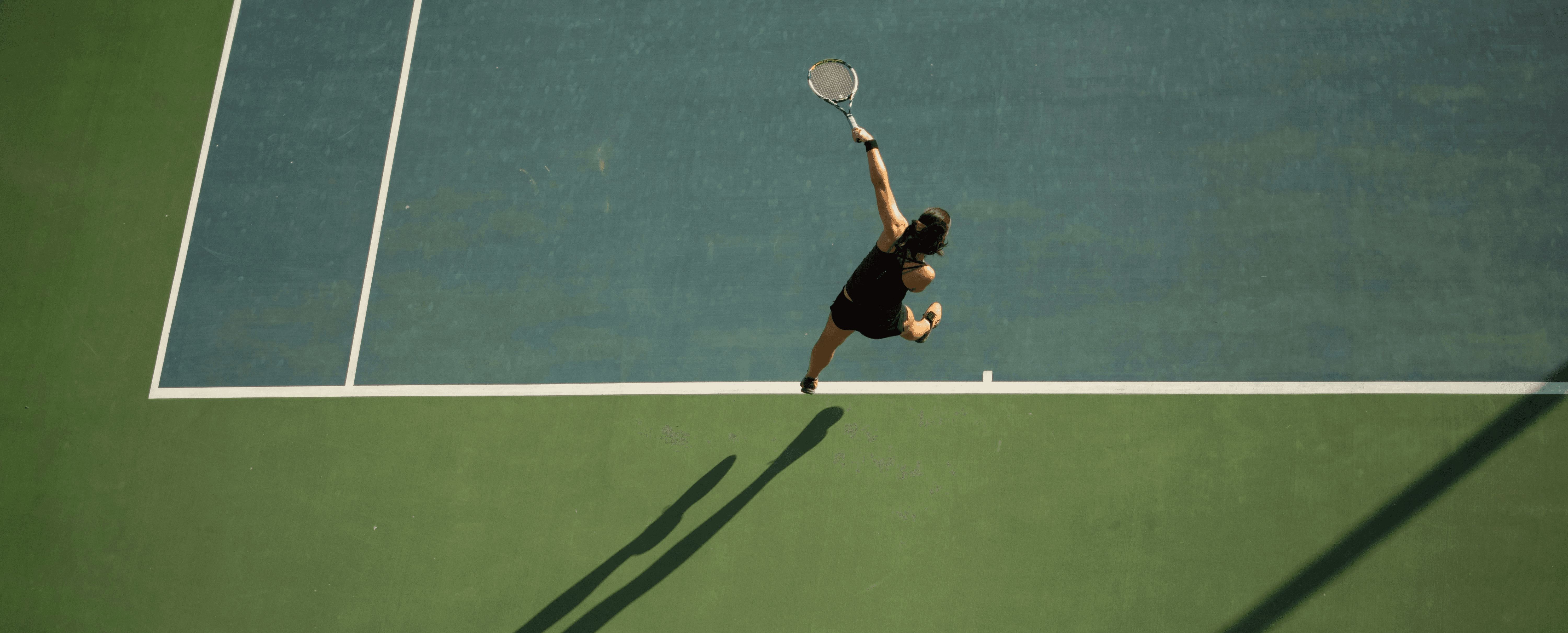 woman in black top holding tennis racket