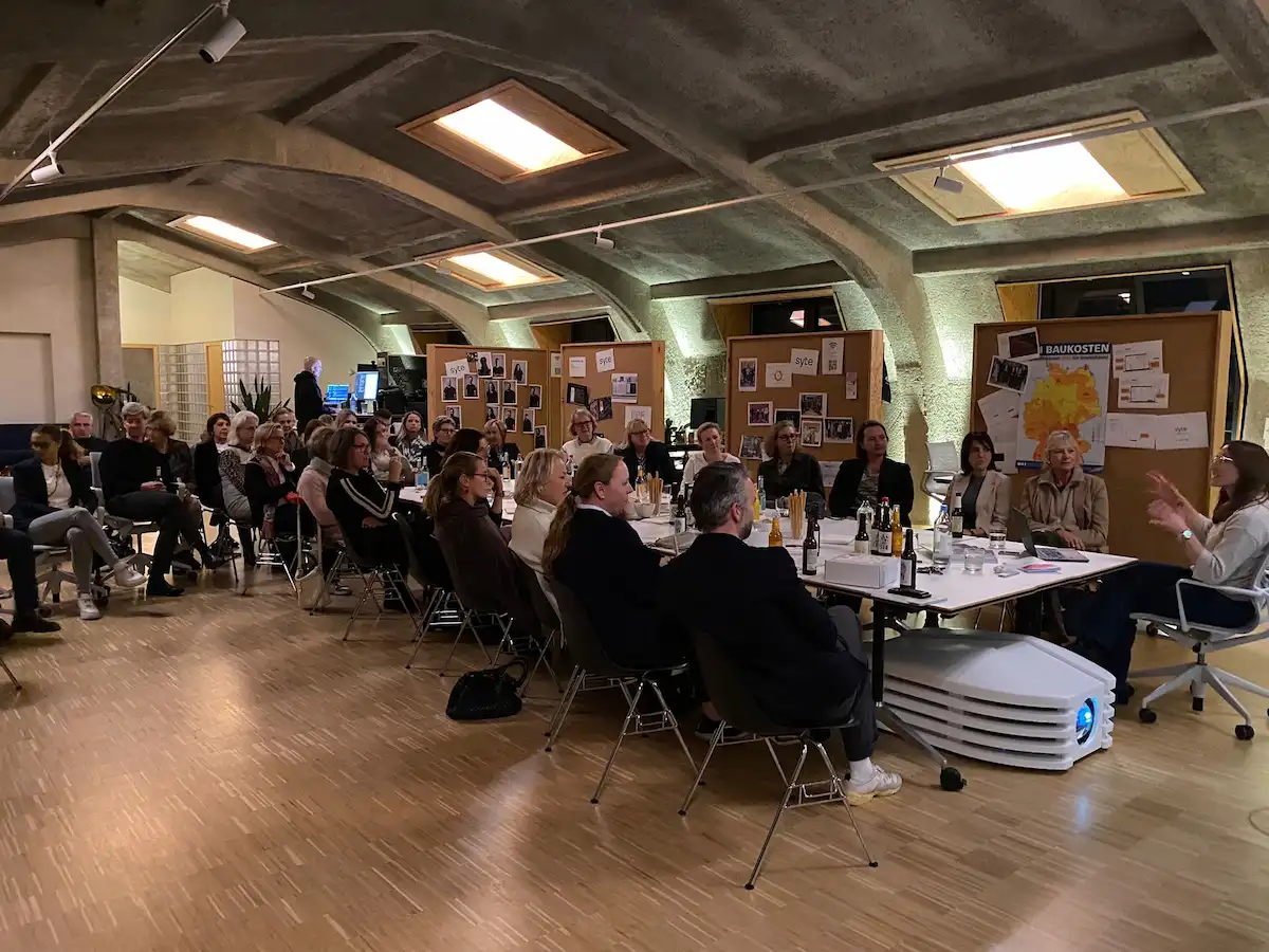 Längliches Wohngebäude mit Klinkerfassade, großen Fenstern und Balkonen über zwei Etagen