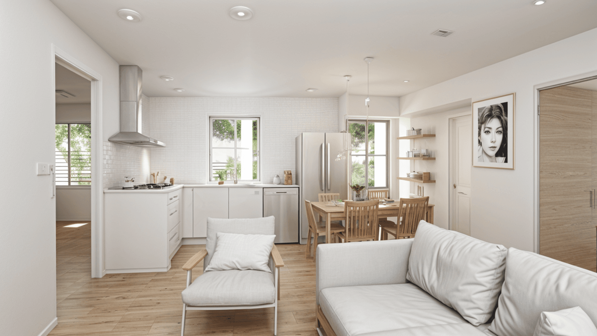 Bright and modern living room with an open-concept kitchen, wooden floors, and minimalist furniture, creating a cozy and welcoming space.