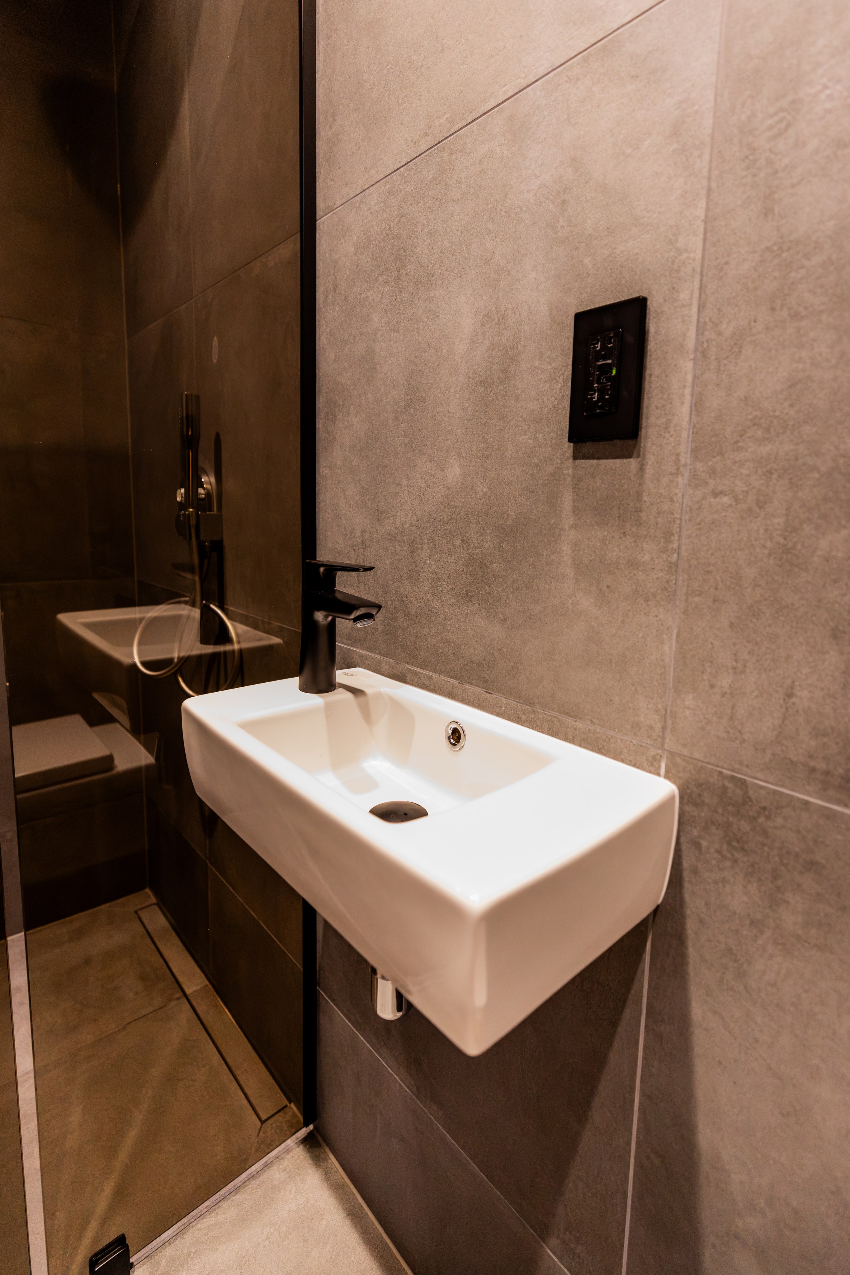Modern compact bathroom with sink and shower