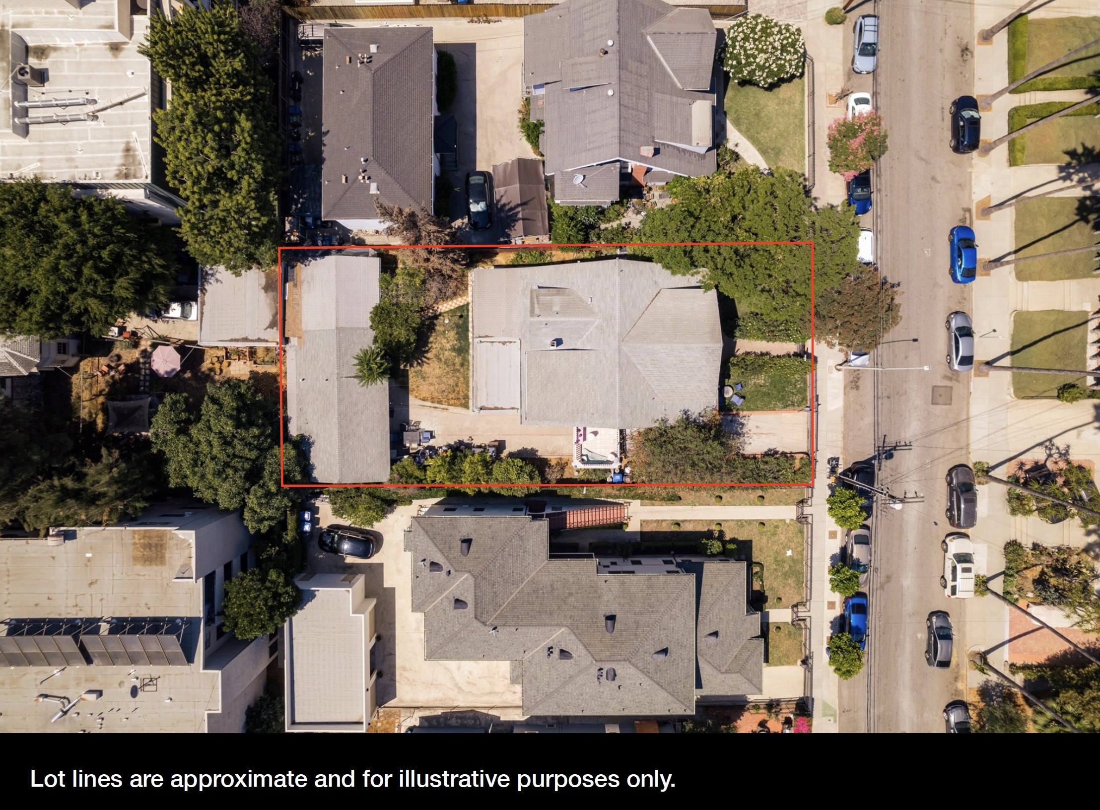 Aerial view of a residential neighborhood at 1807 n van ness, showcasing houses and surrounding trees along a street.