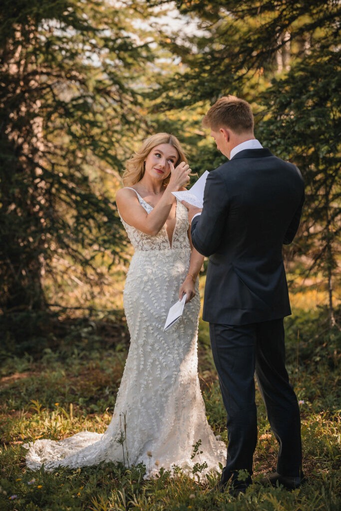 Bride adjusting the groom’s tie during their first look
