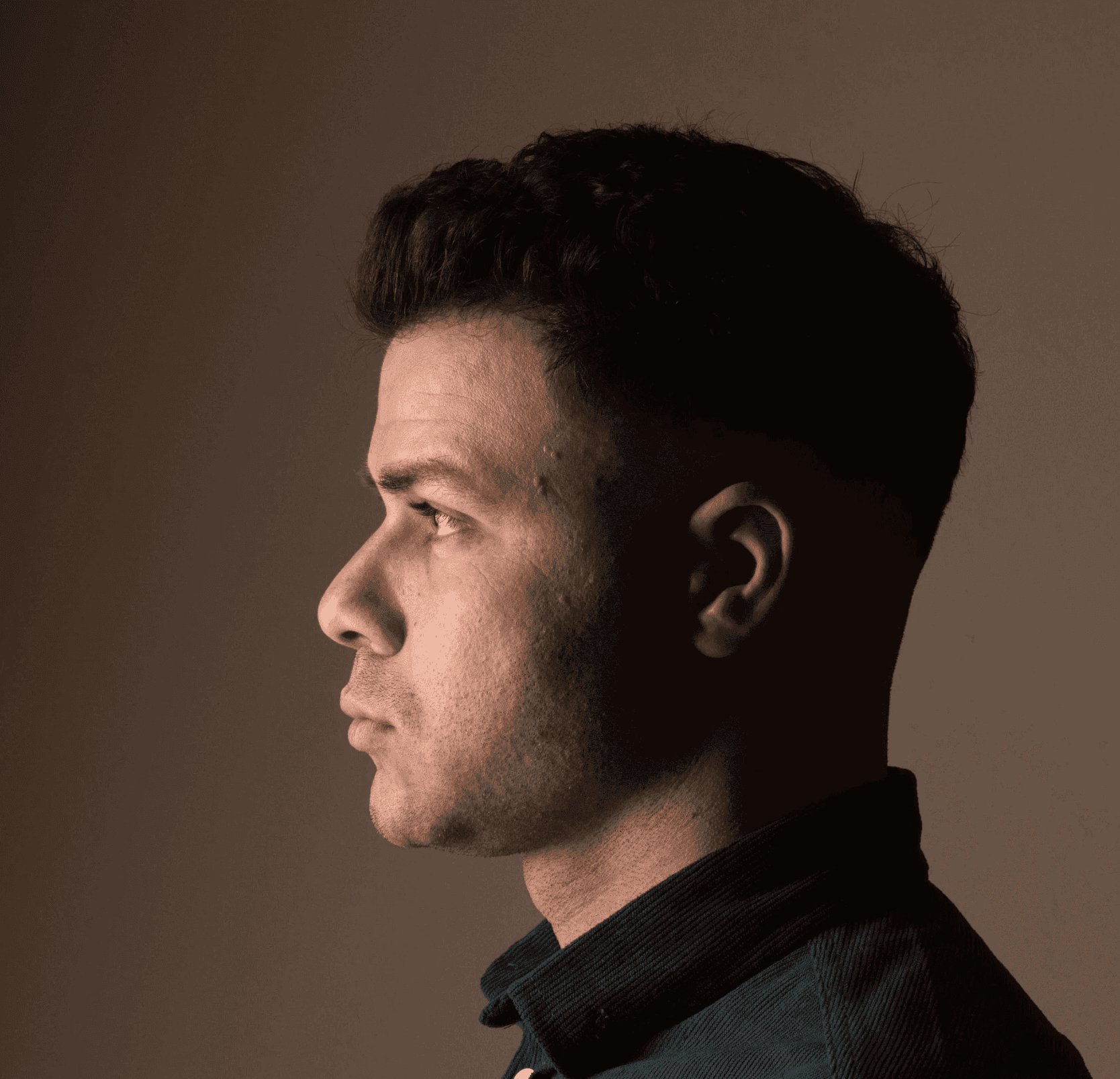 a young man wearing a hat and a t - shirt