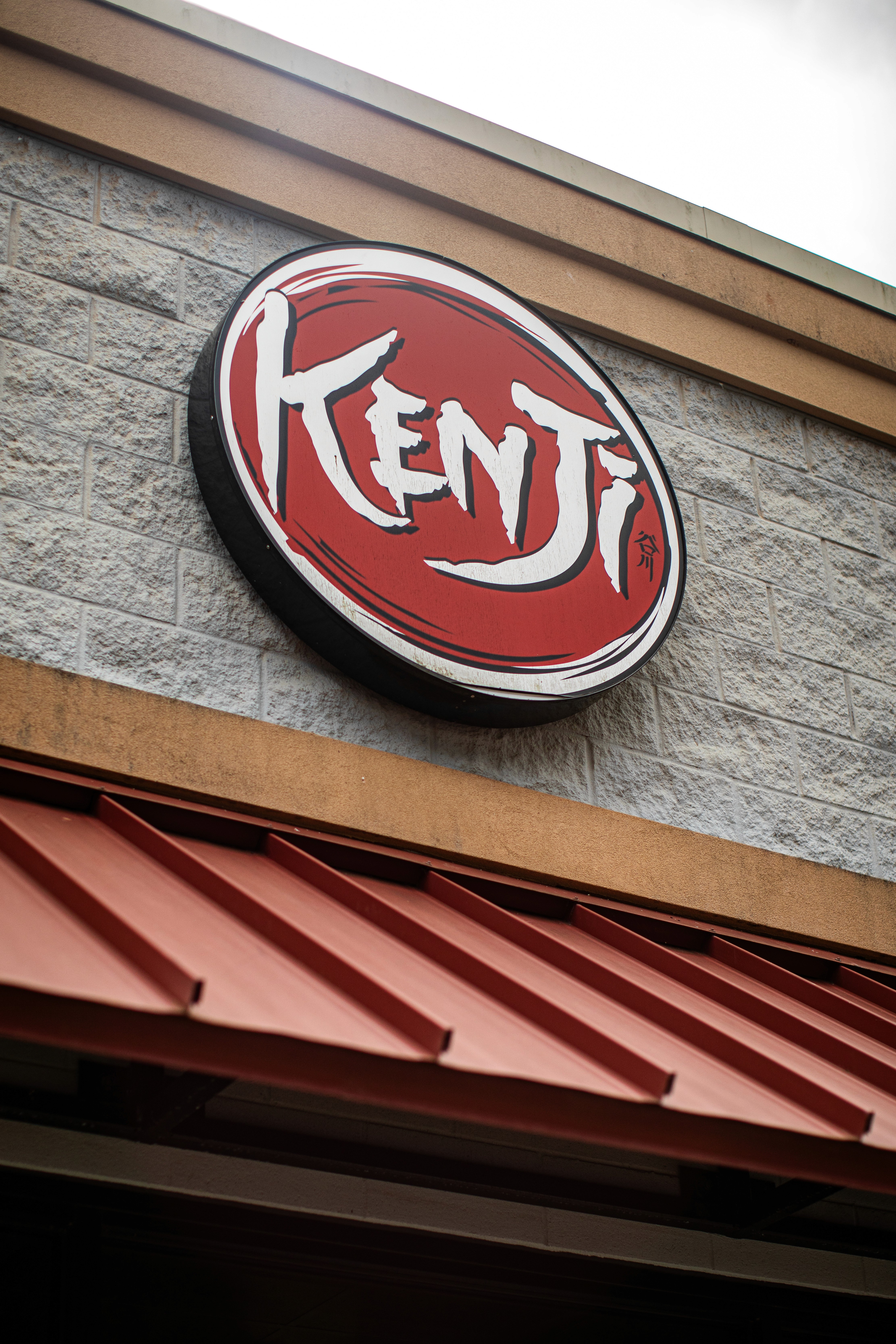 A cluttered dining table with plates, glasses, and food remnants, illuminated by soft, warm lighting.