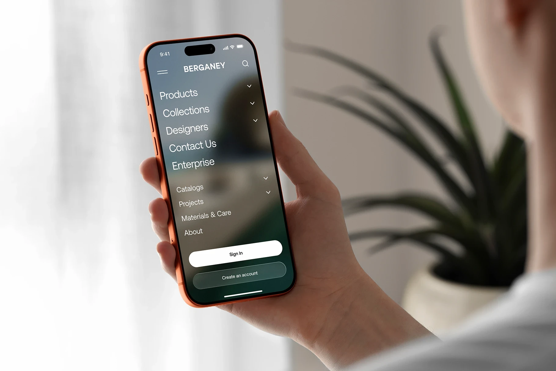 Over-the-shoulder perspective of a person using a dark mode interface on an Cosmic Orange iPhone 17 Pro mockup.