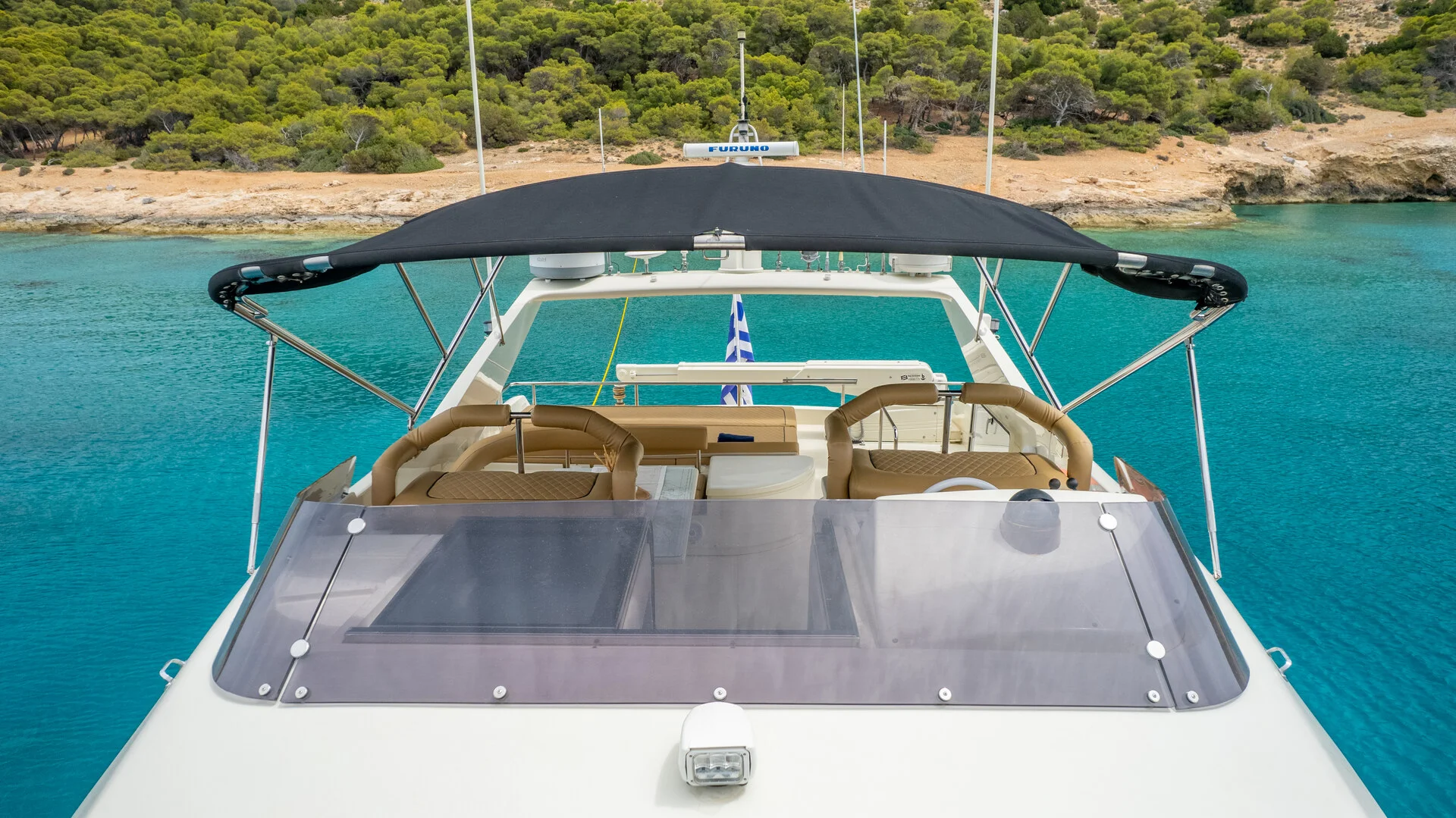 White Rock 36 speedboat with captain at helm cruising calm blue waters near Paros coastline with hills in background.