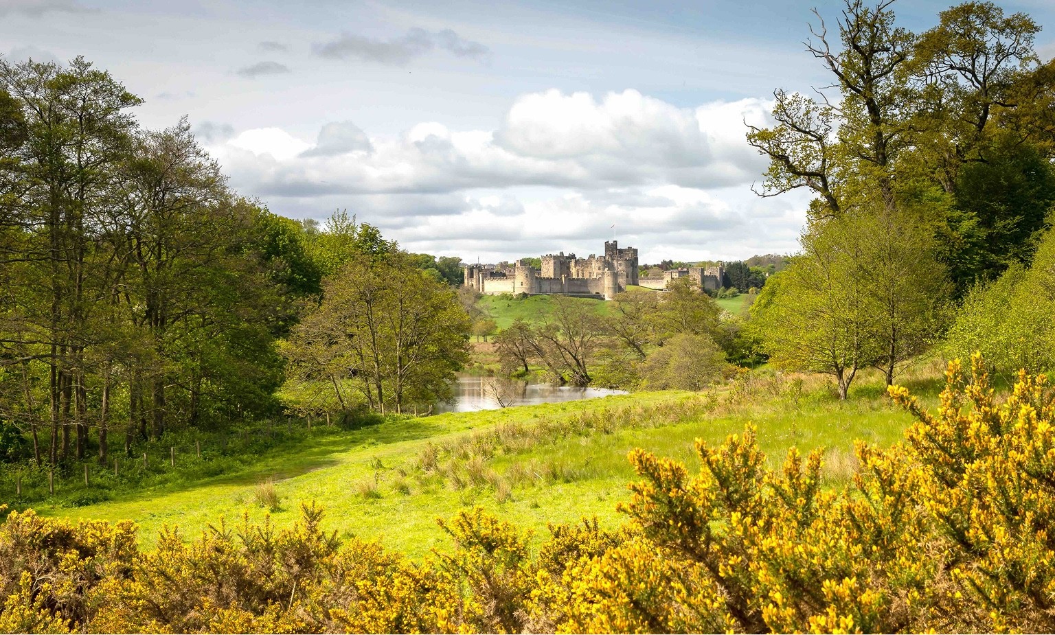 Historic English castle set within ordered countryside, symbolising structure, separation, and long-term clarity in family trusts and trust funds.