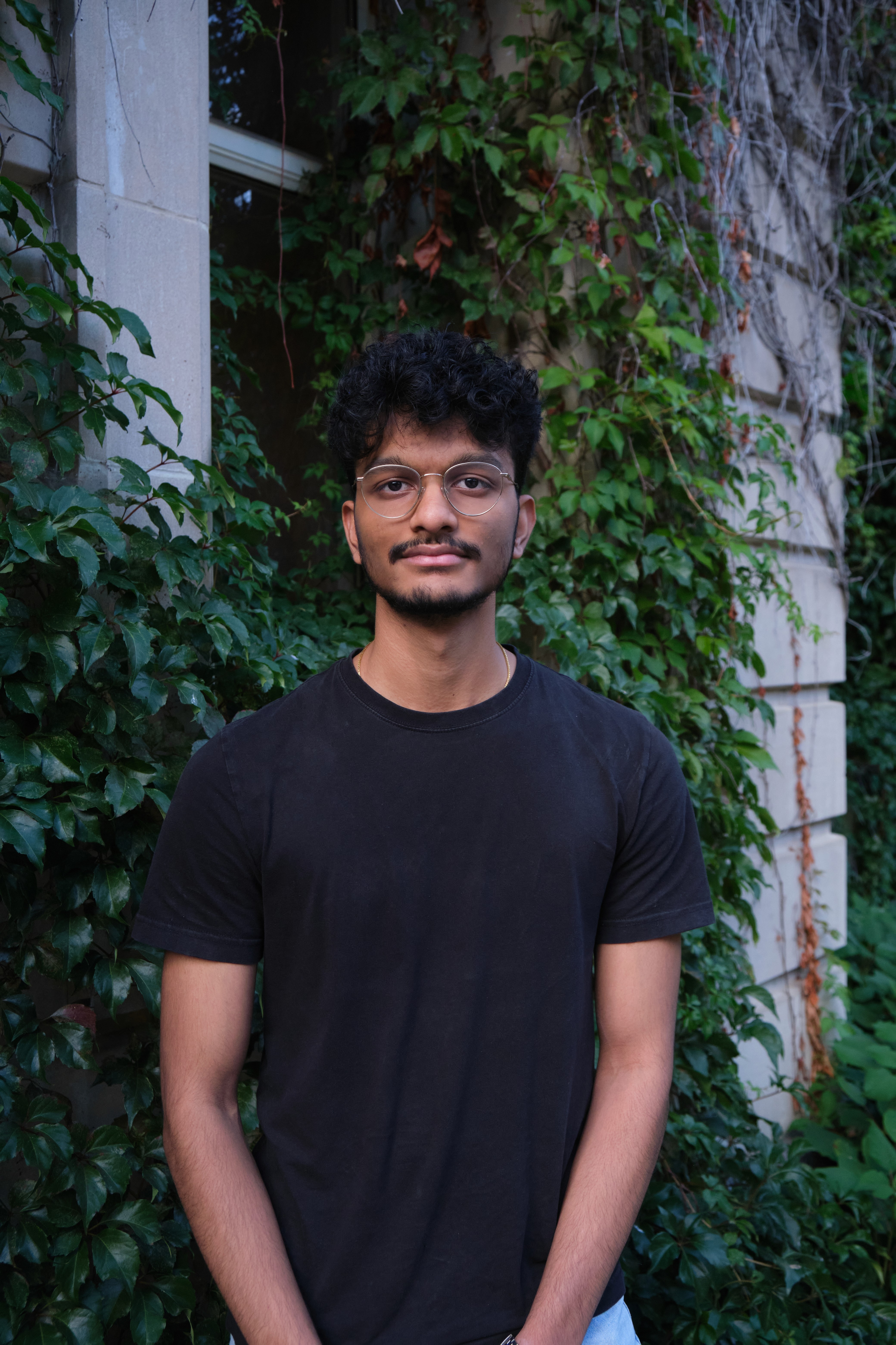 Man in black track suit on a track. Coaching or athlete.