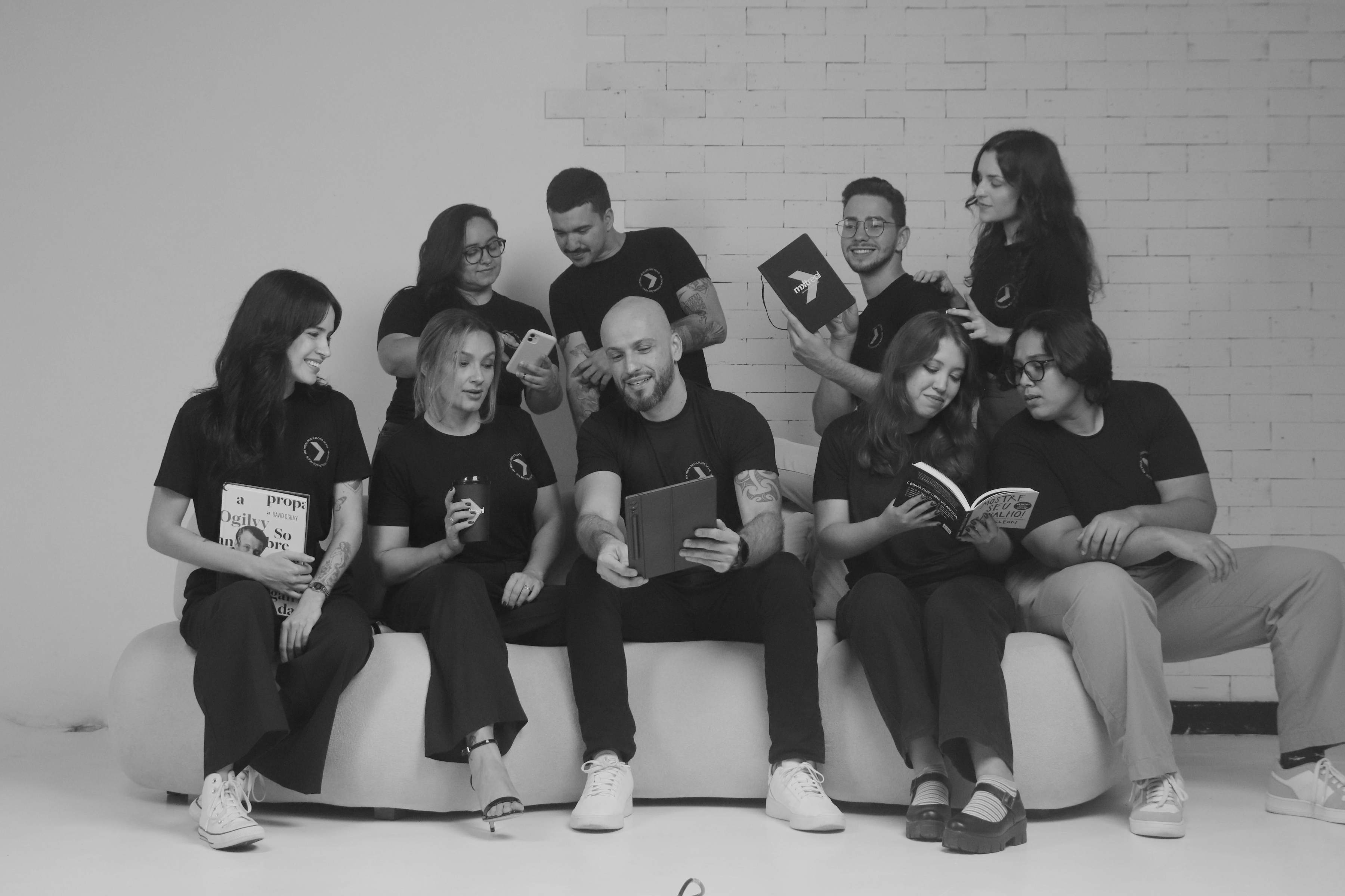 person in red sweater holding babys hand