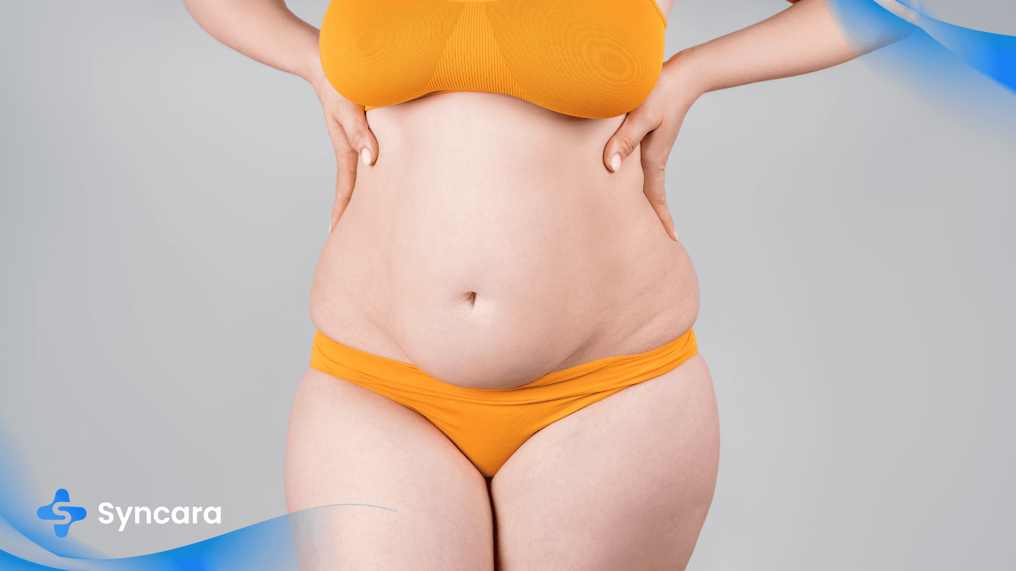 Woman in an orange bathing suit with tummy fat, illustrating a pre-tummy tuck condition.
