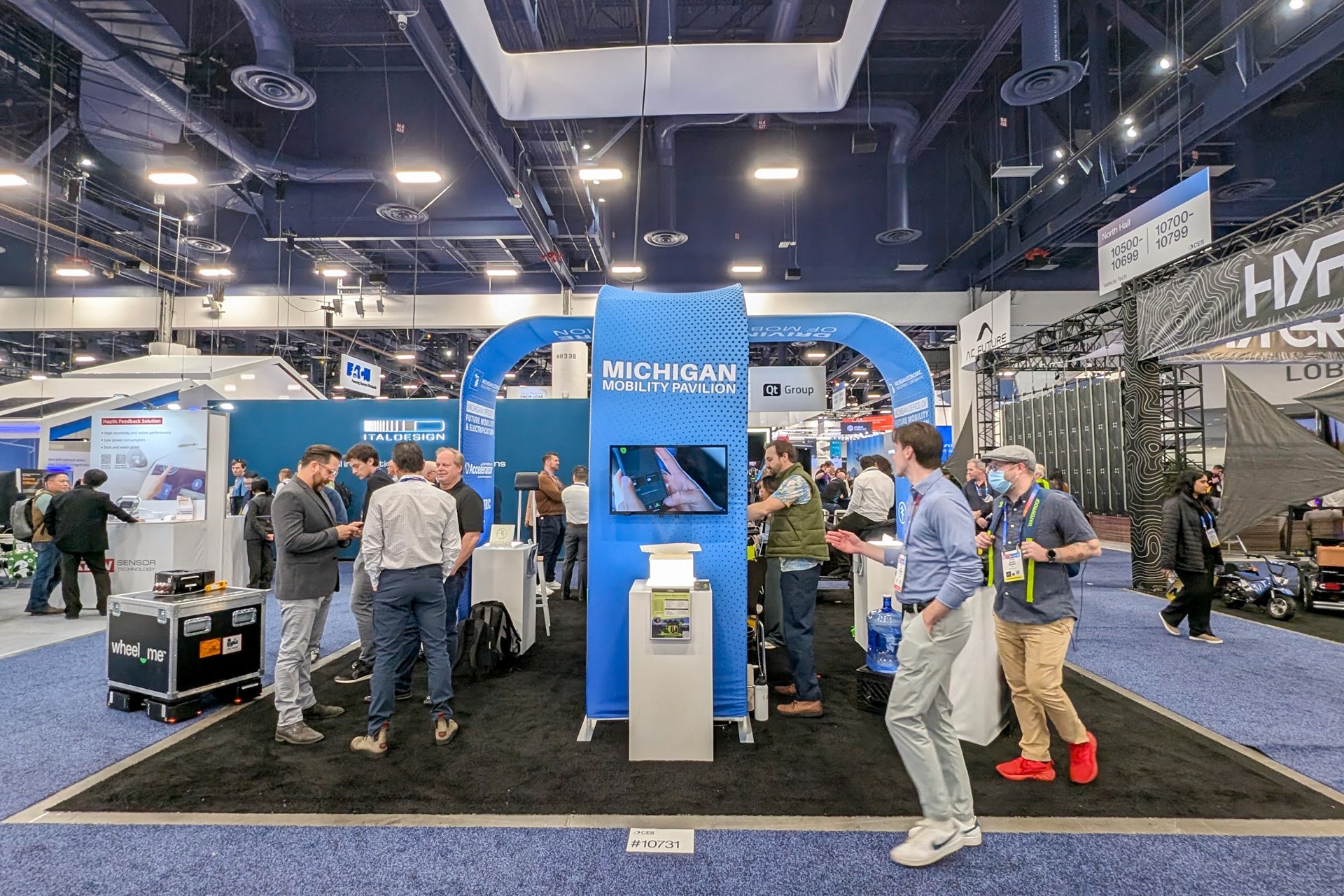 A busy booth at an indoor trade show