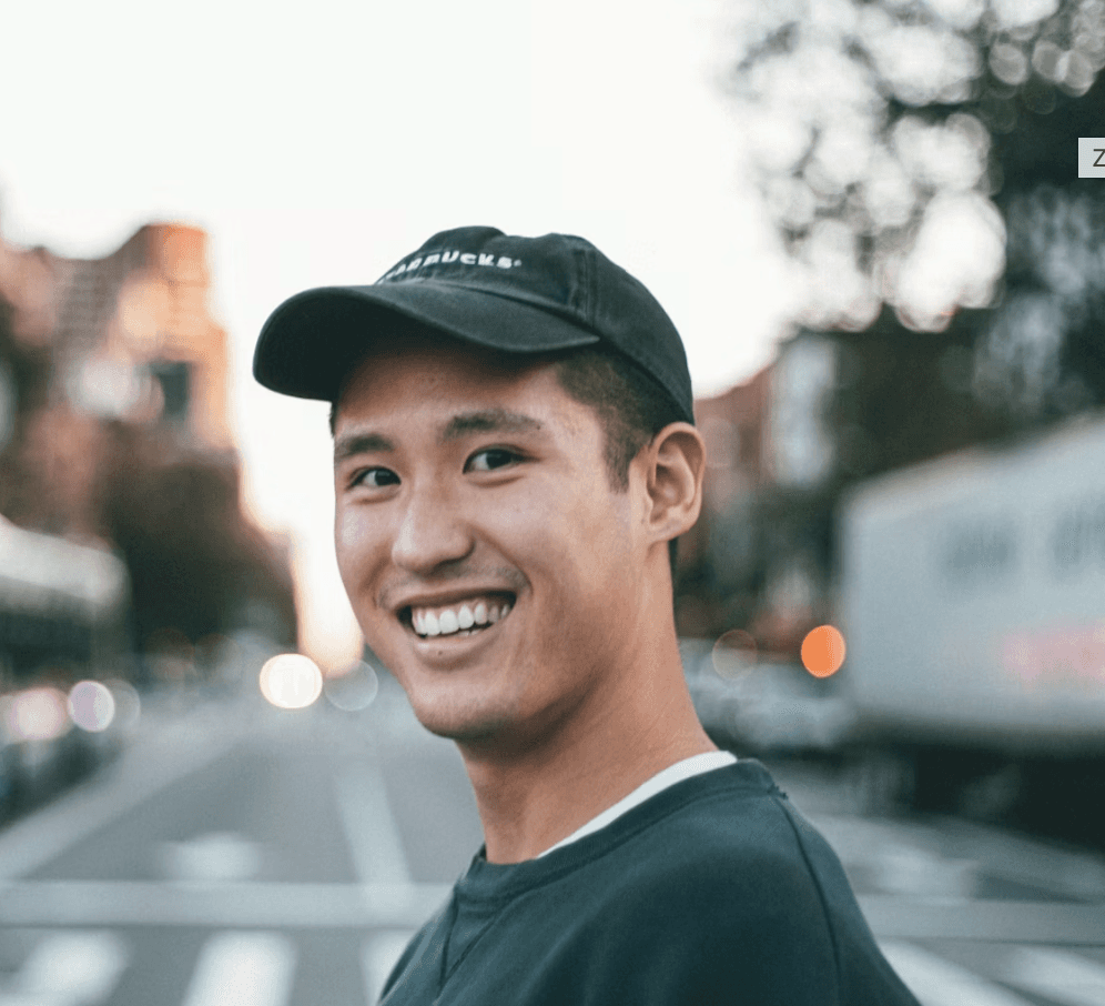 smiling woman wearing white and black pinstriped collared top